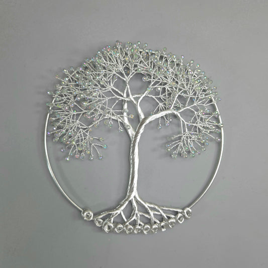Silver tree-shaped decorative wall art on a gray background