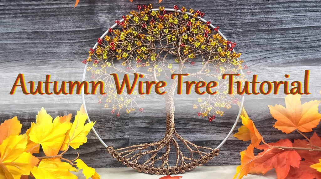 Autumn wire tree decoration with leaves on a wooden background