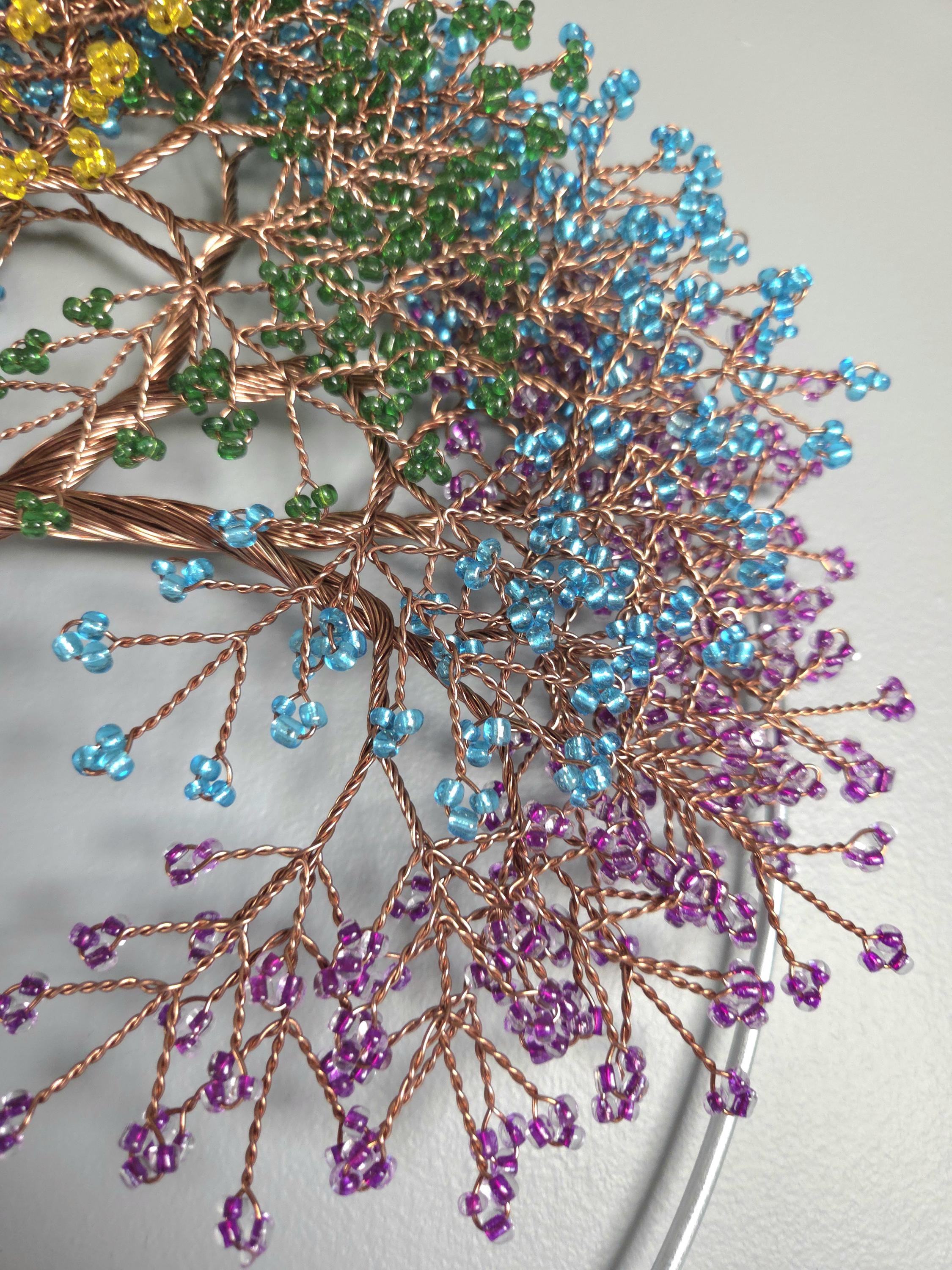 Decorative branch with colorful beads on a neutral background