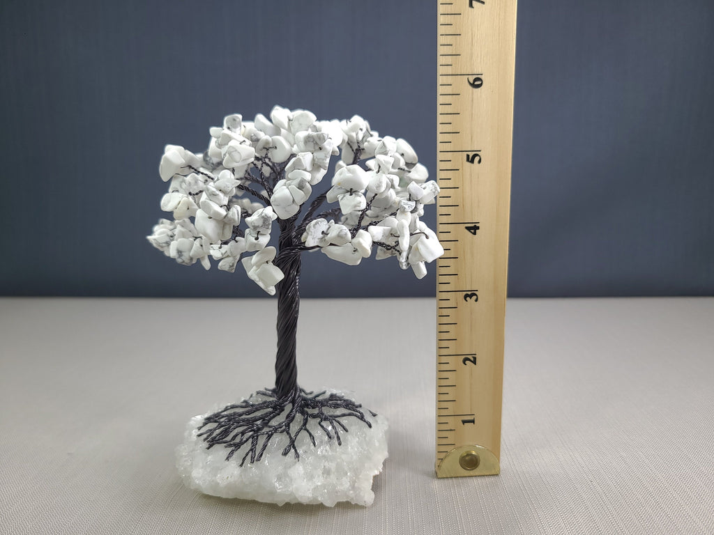 Decorative white tree with a ruler for scale on a gray background