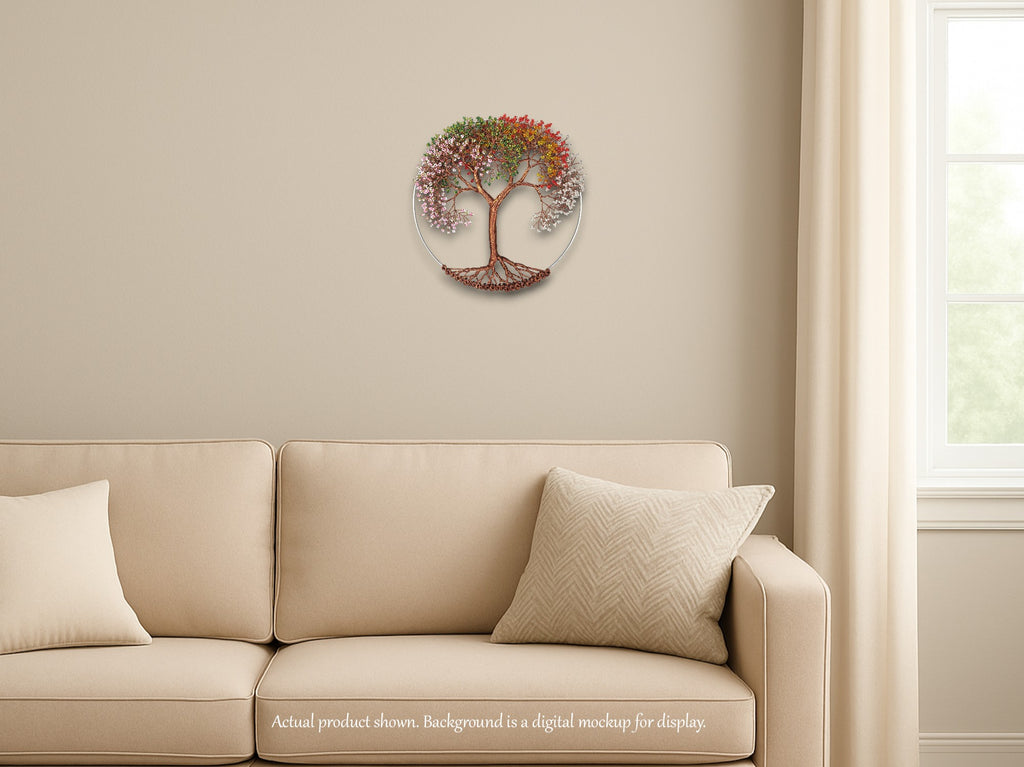 Decorative wall clock with tree design on a beige wall above a beige sofa.