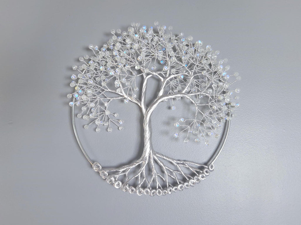 Decorative silver tree wall art on a gray background