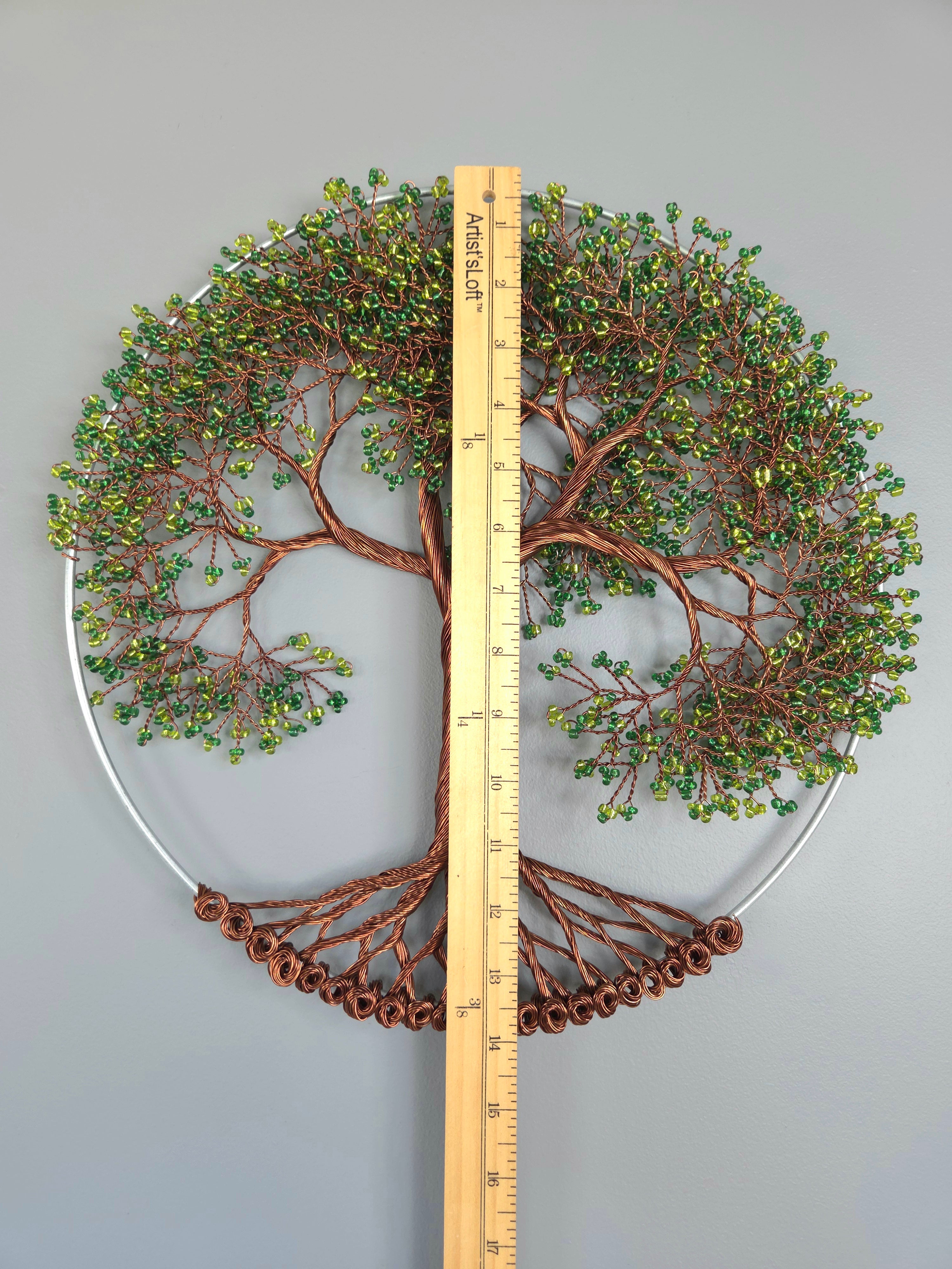 Decorative wall art of a tree with branches and leaves, measured against a ruler for scale.