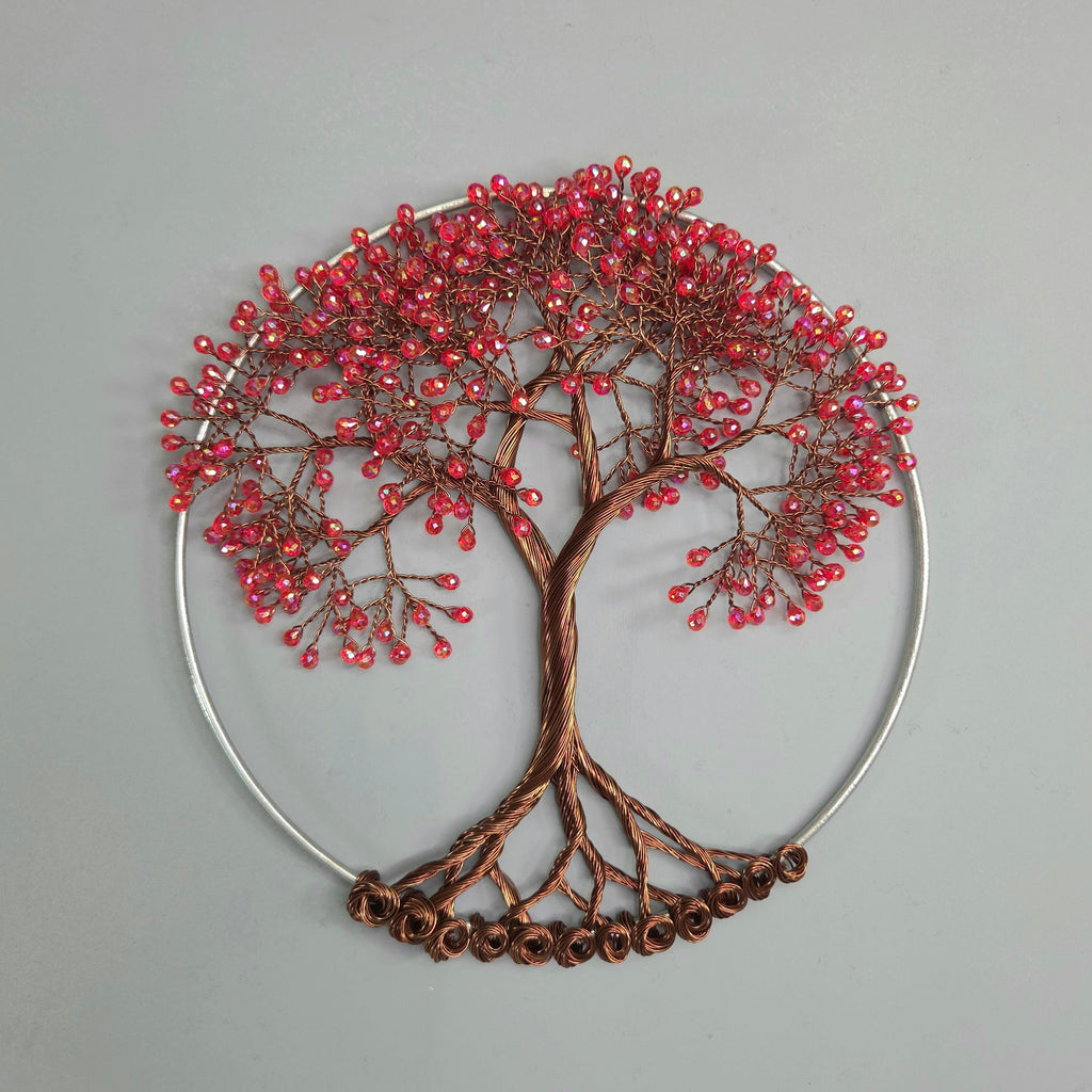 Decorative wall art of a tree with red berries on a gray background