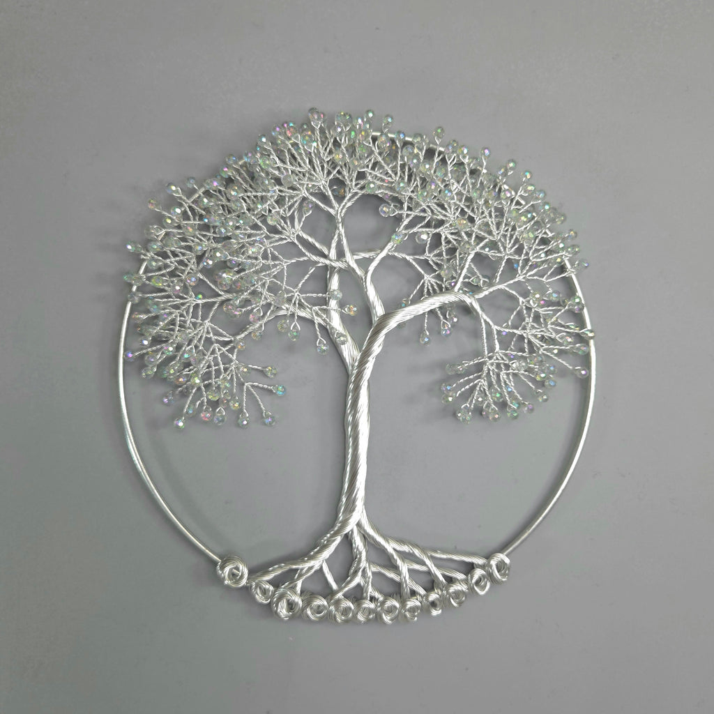Silver tree-shaped decorative wall art on a gray background