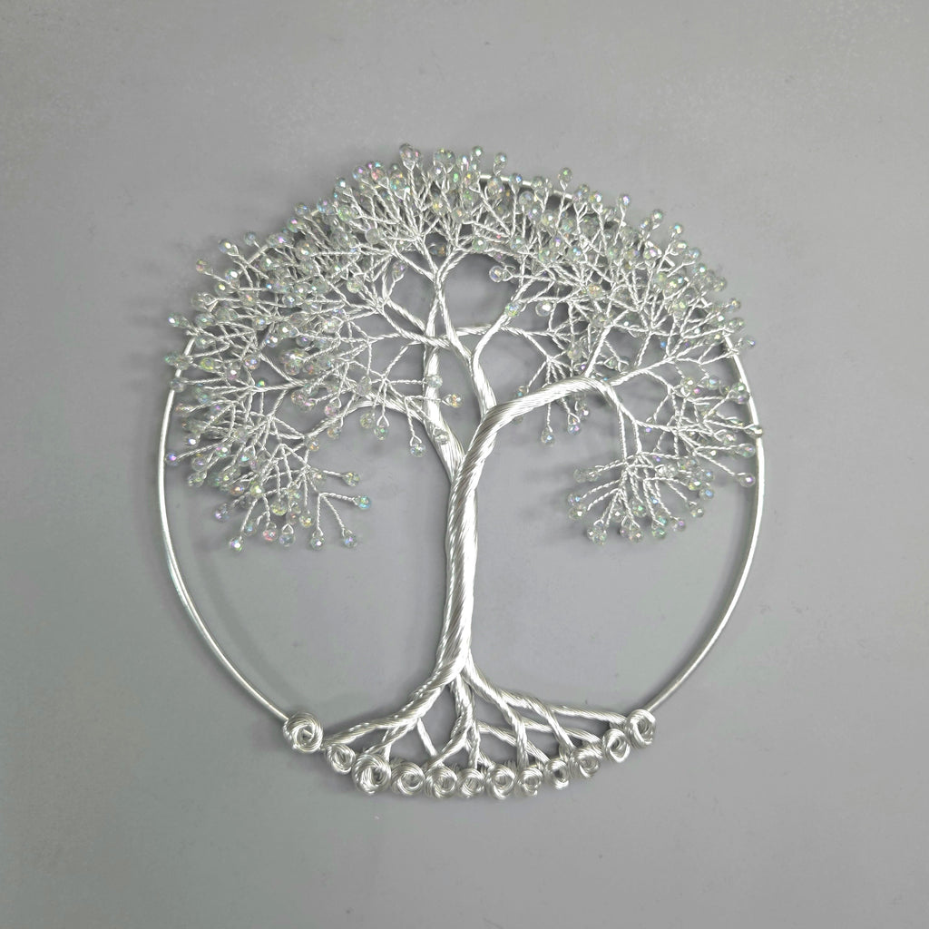 Silver tree-shaped decorative wall art on a gray background