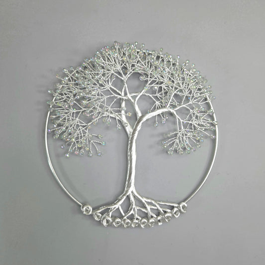 Silver tree-shaped decorative wall art on a gray background