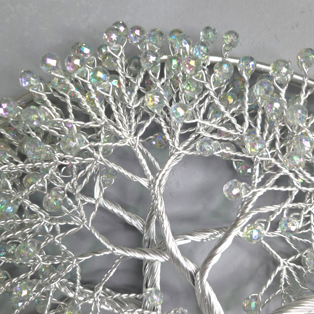 Decorative wreath with crystal-like beads on a plain background