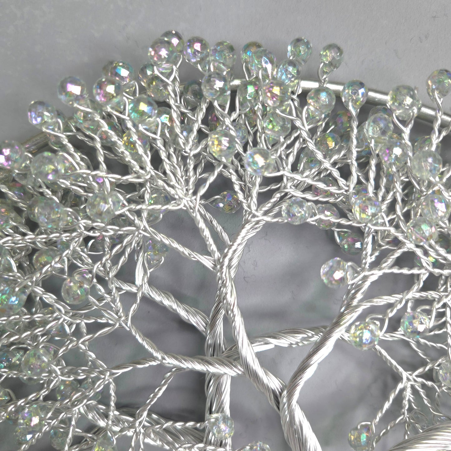 Decorative wreath with crystal-like beads on a plain background