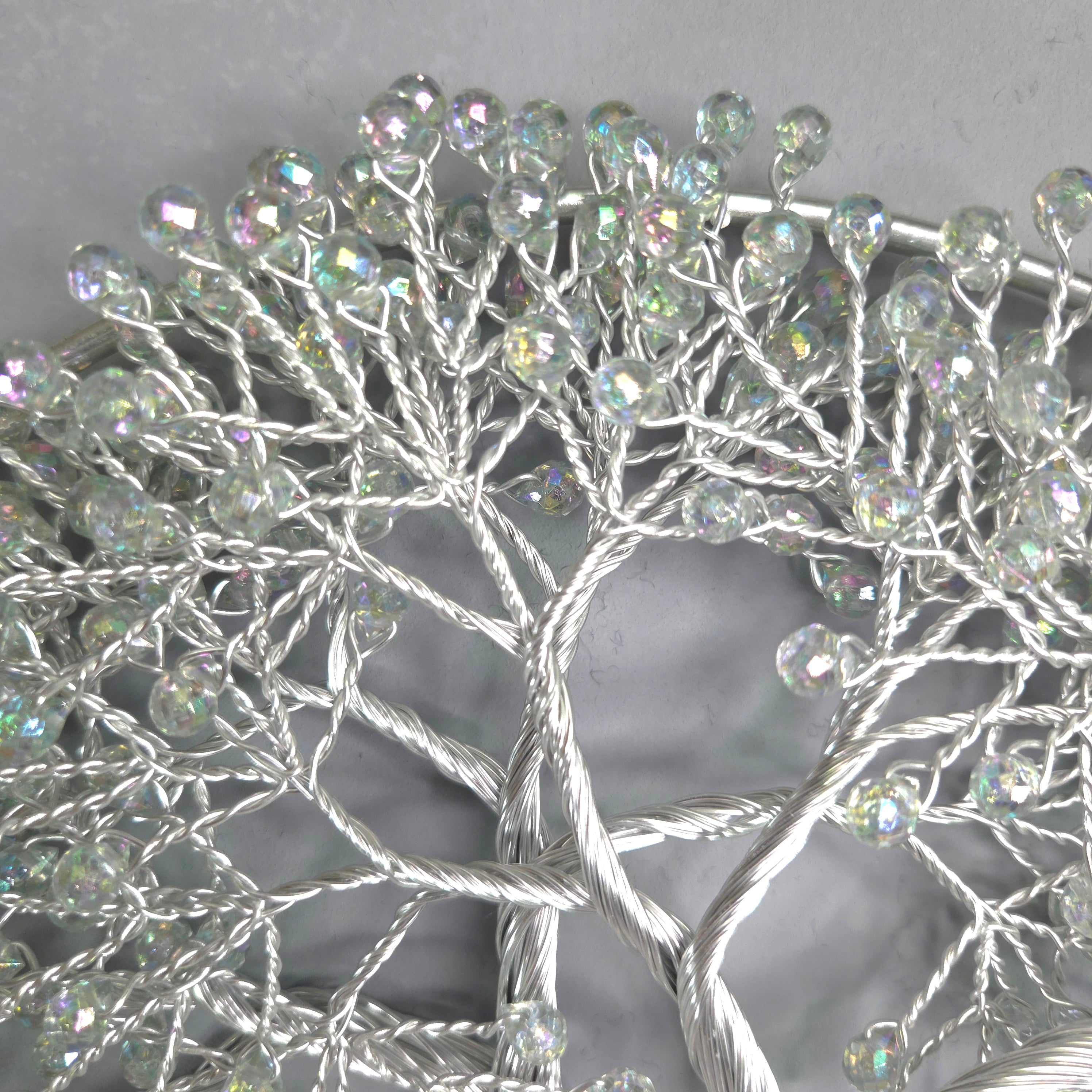 Decorative wreath with crystal-like beads on a plain background