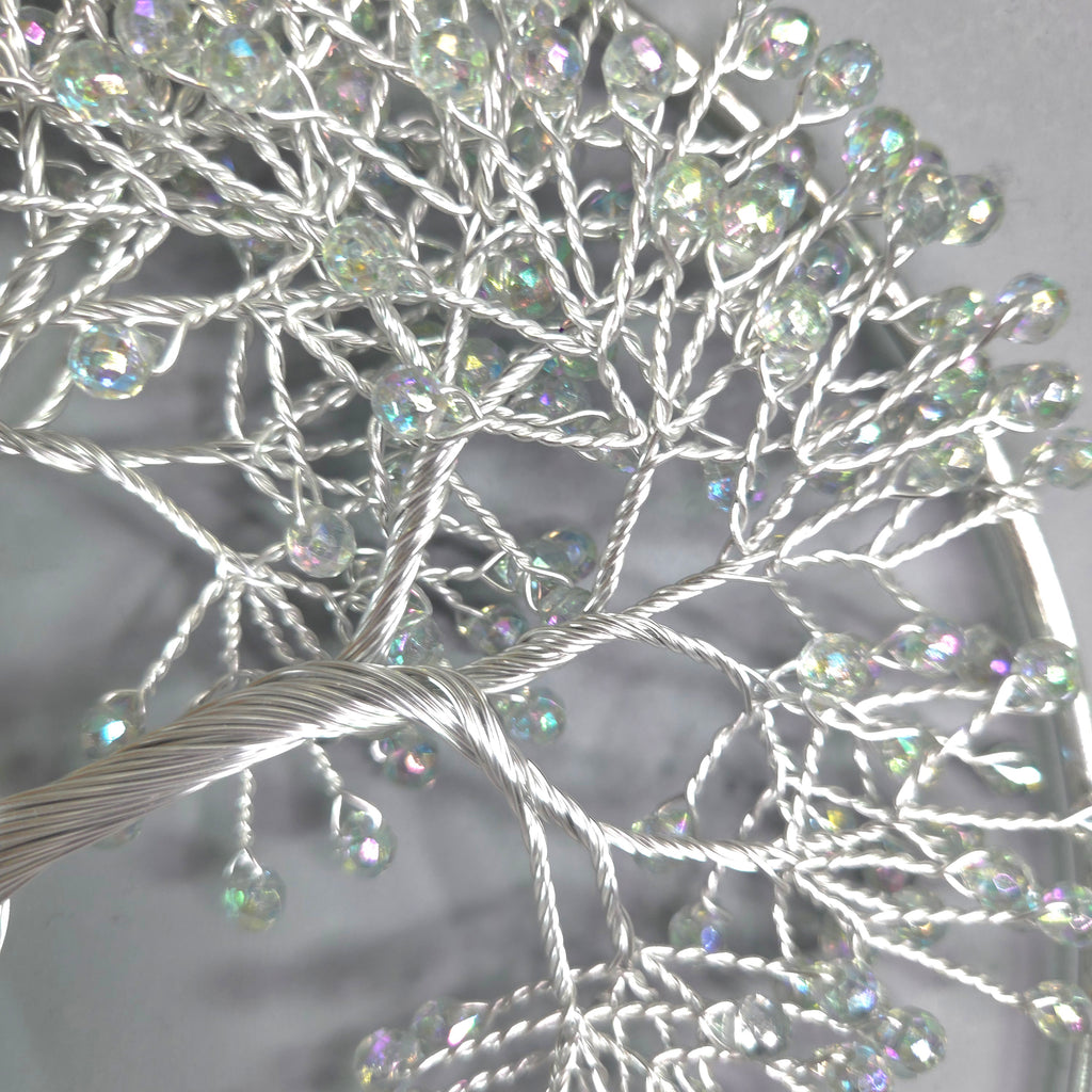 Decorative branch with crystal-like beads on a gray background