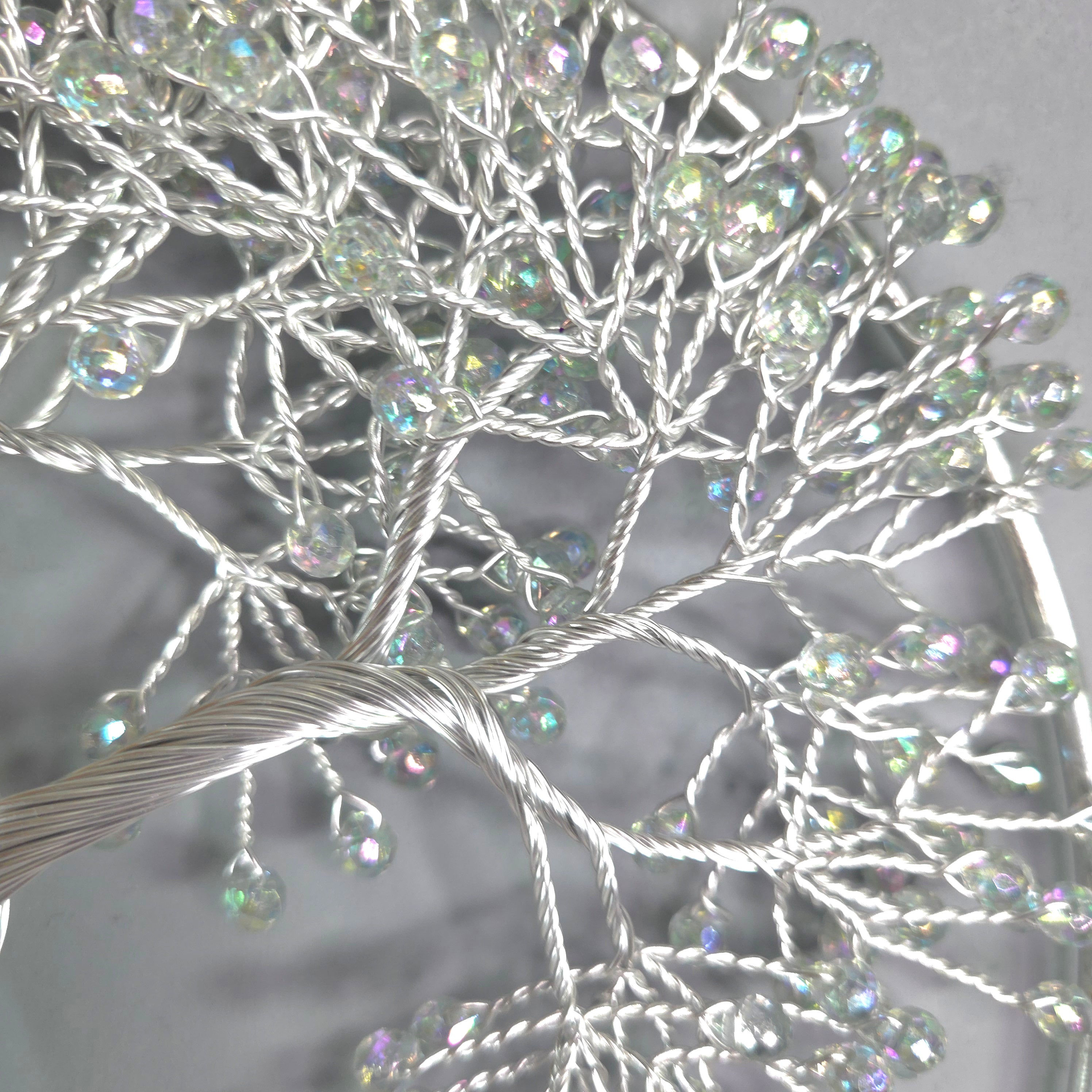 Decorative branch with crystal-like beads on a gray background