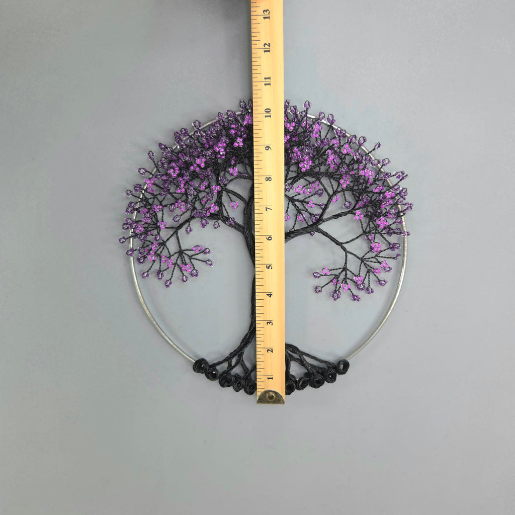 Decorative tree wall art with purple branches and a ruler for scale on a gray background