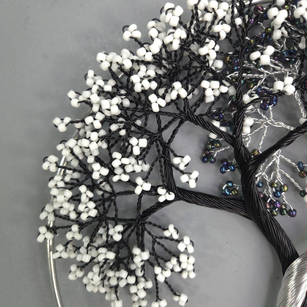 Decorative tree made of wire and beads on a gray background
