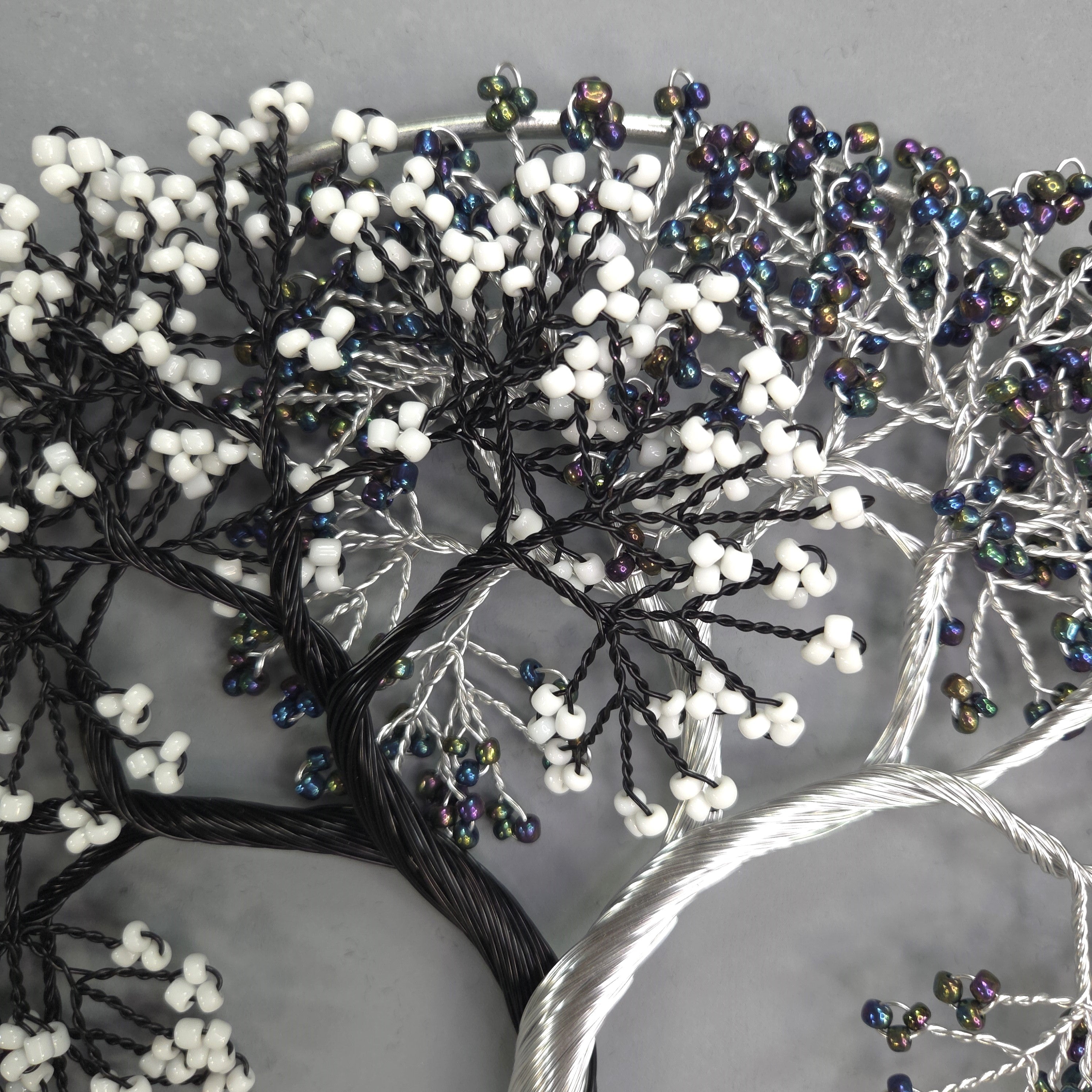 Decorative tree with beaded branches on a gray background