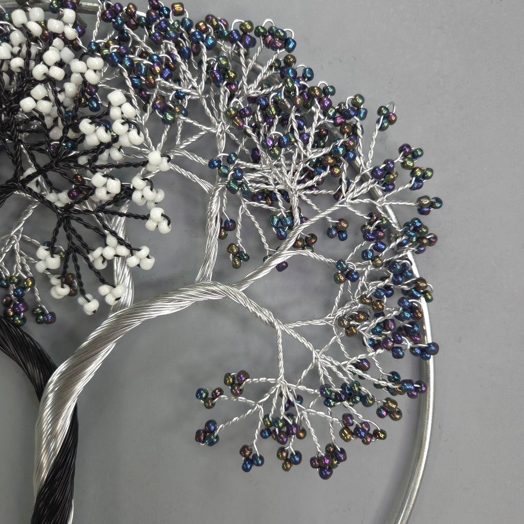 Decorative hair accessory with beaded branches on a gray background