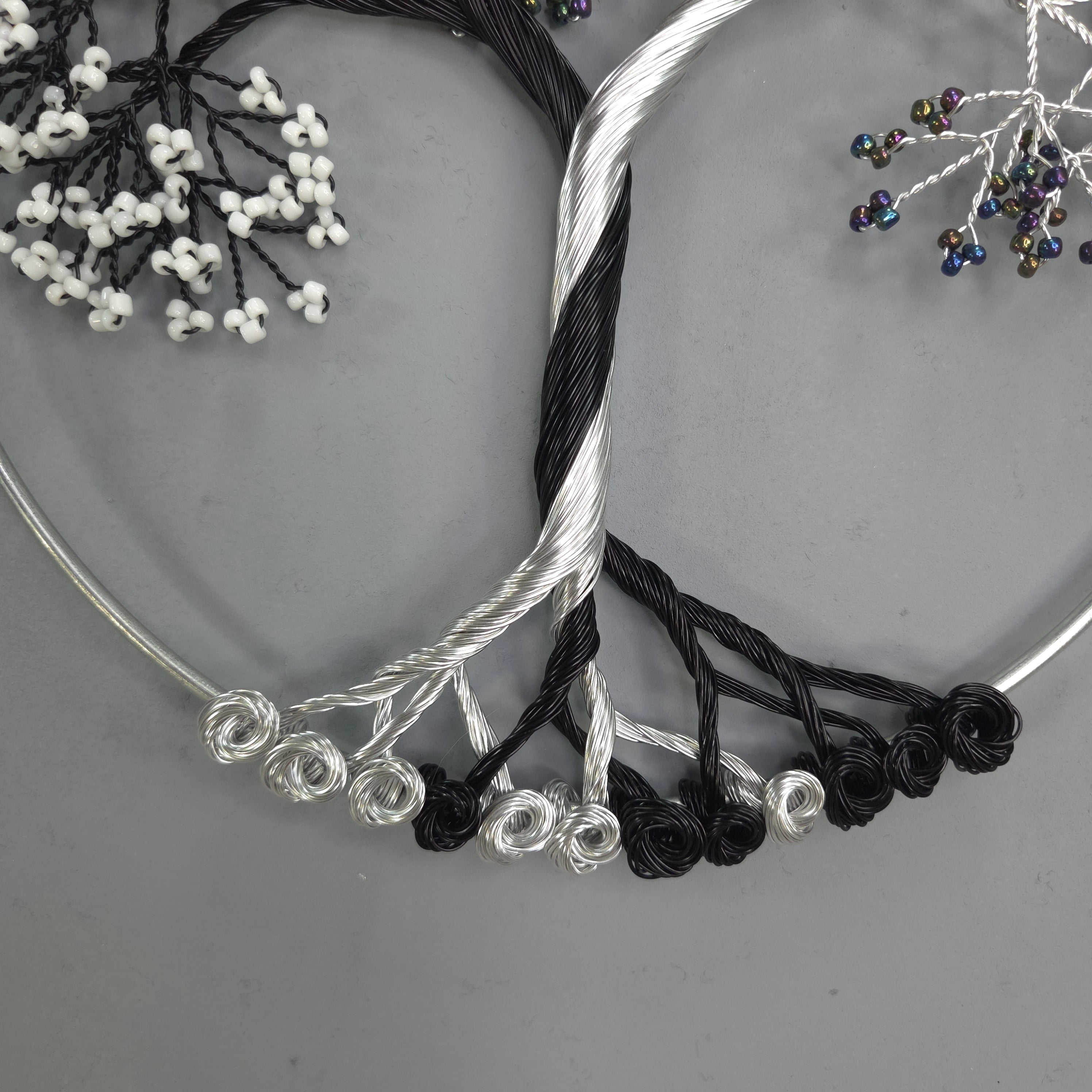 Silver and black jewelry on a gray surface