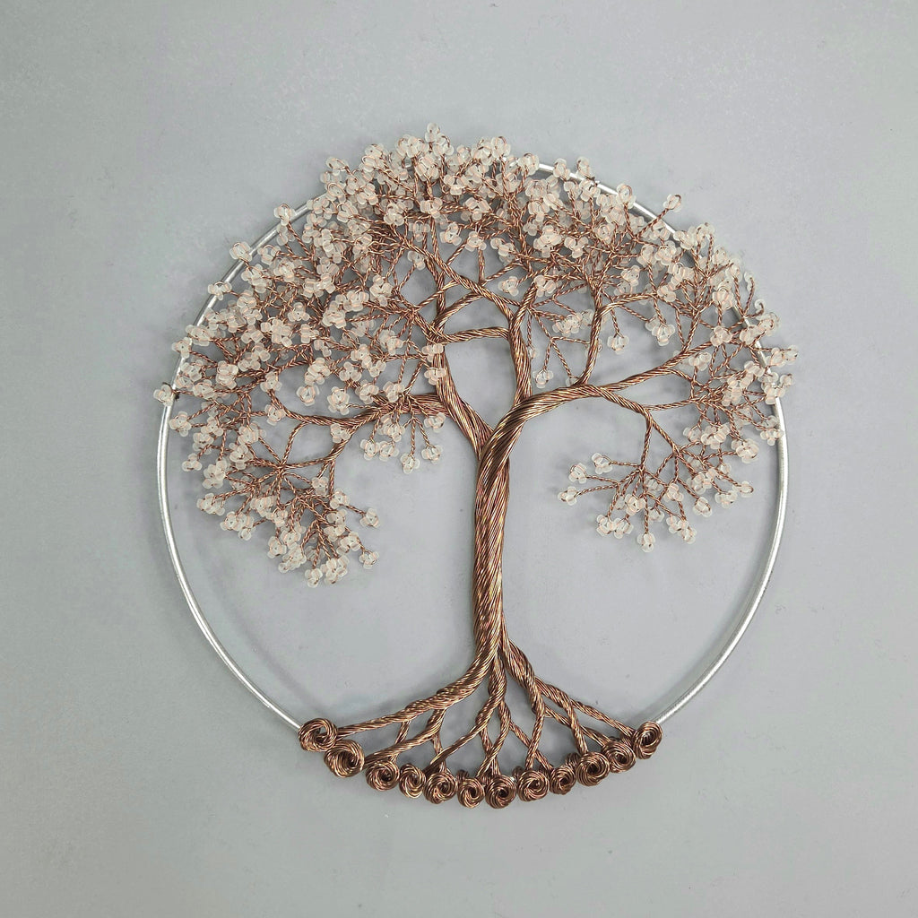 Decorative wall art of a tree with branches and leaves on a gray background
