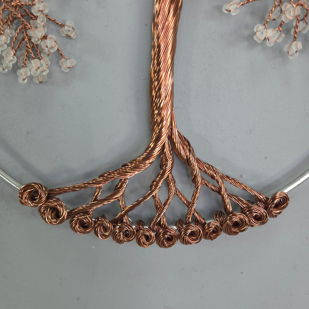 Close-up of a decorative copper wire piece on a gray background