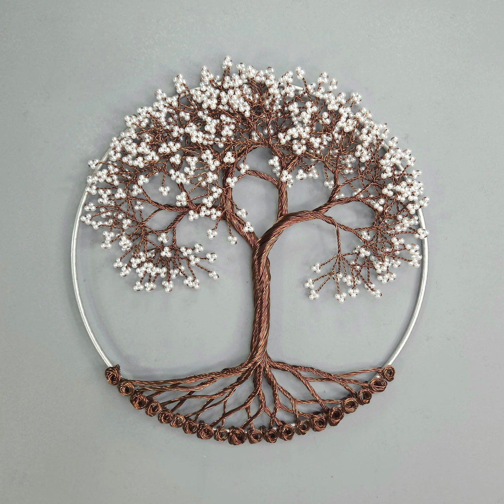 Decorative wall art of a tree with branches and leaves on a gray background