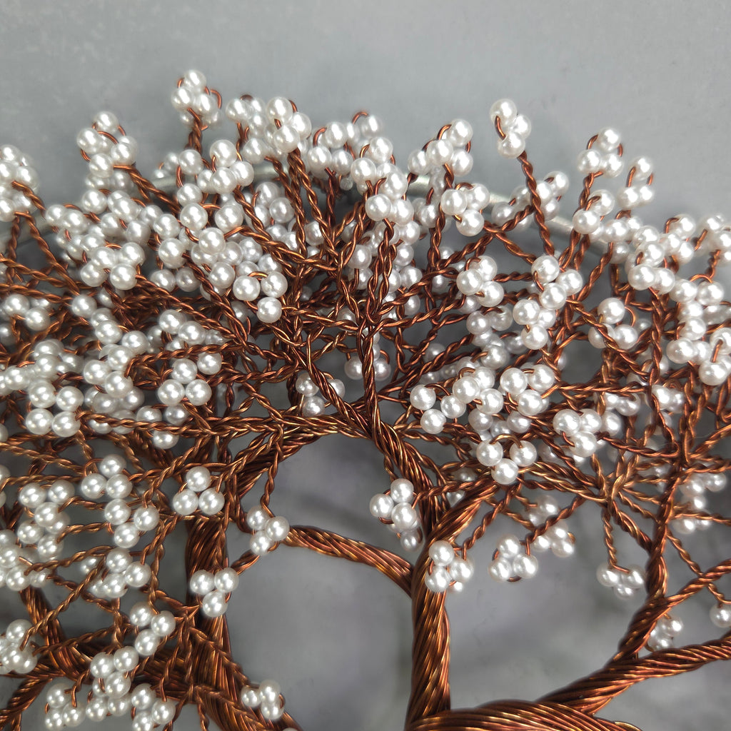 Decorative branch with white berries and brown branches on a gray background