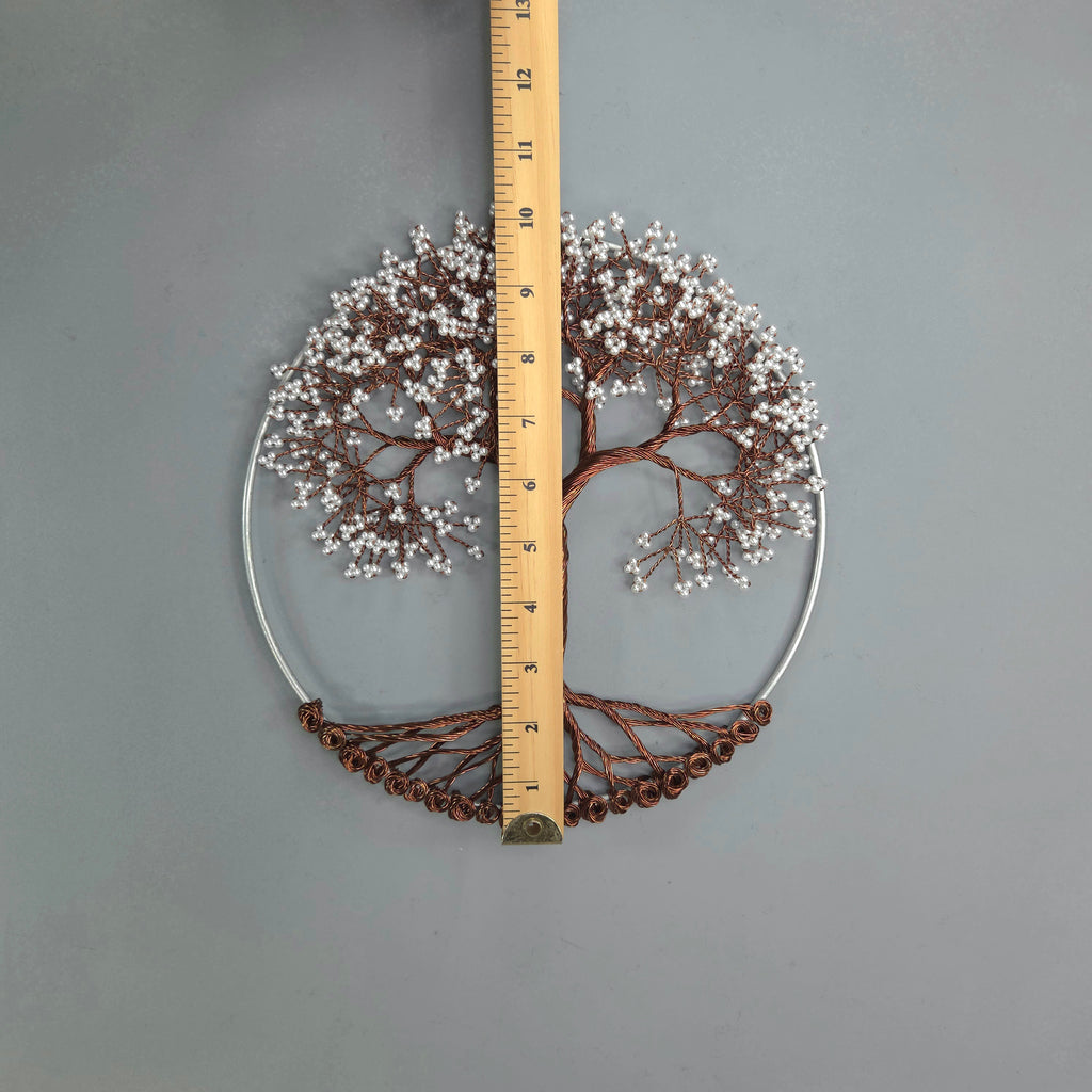 Decorative wall art with tree design and measurement ruler on a gray background