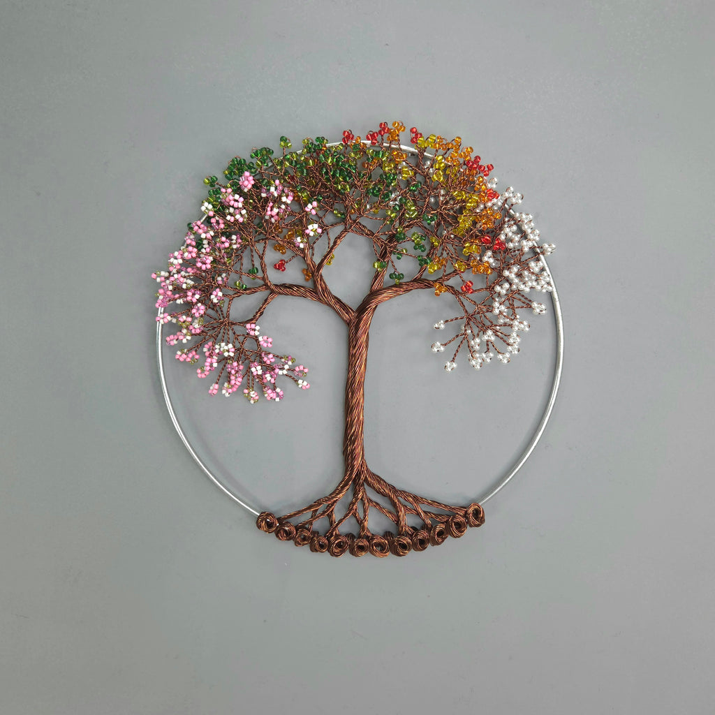 Decorative wall art of a tree with四季变化的叶子 on a gray background