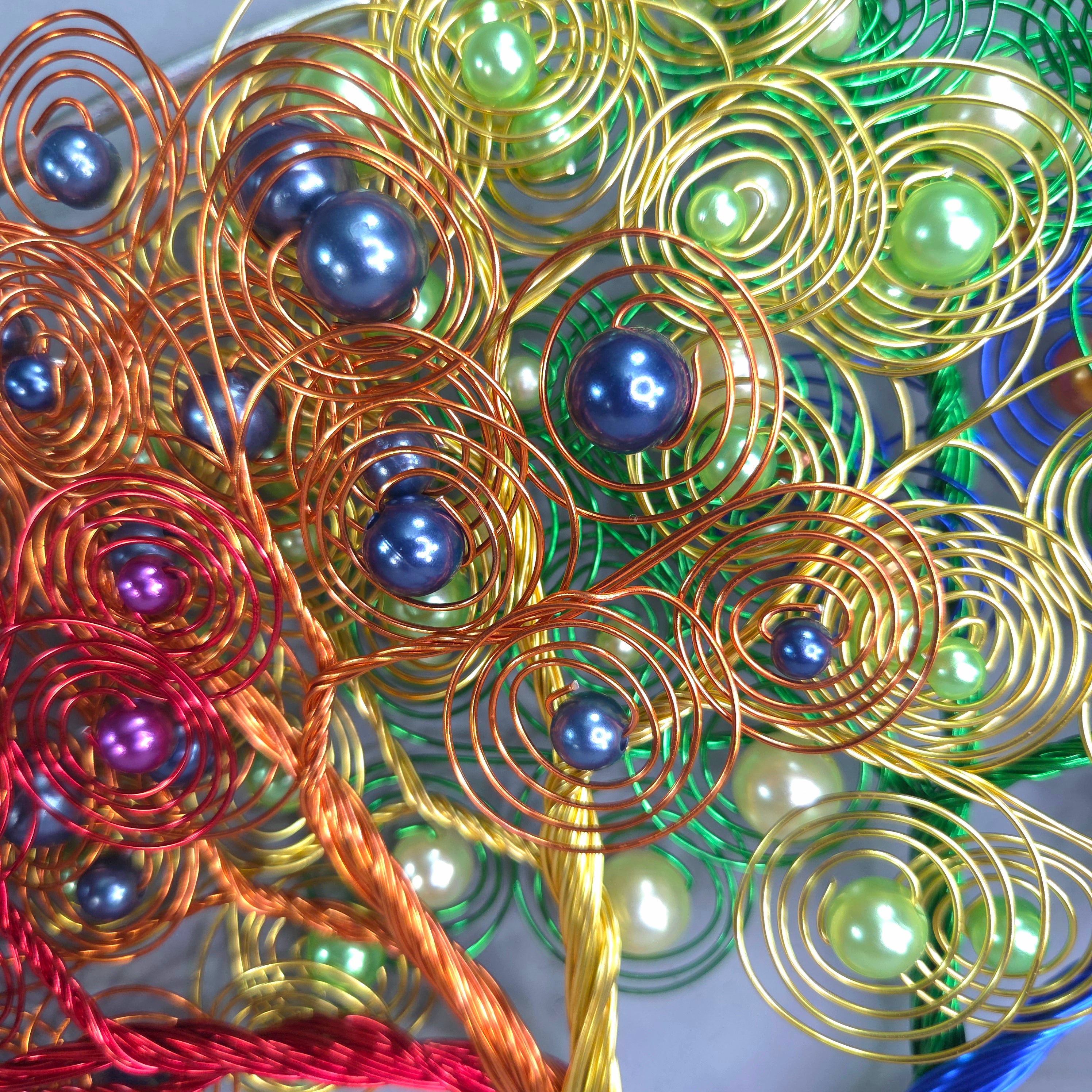 Colorful wire and bead decorative item with swirl patterns