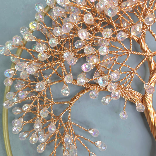 Decorative branch with beads on a light blue background