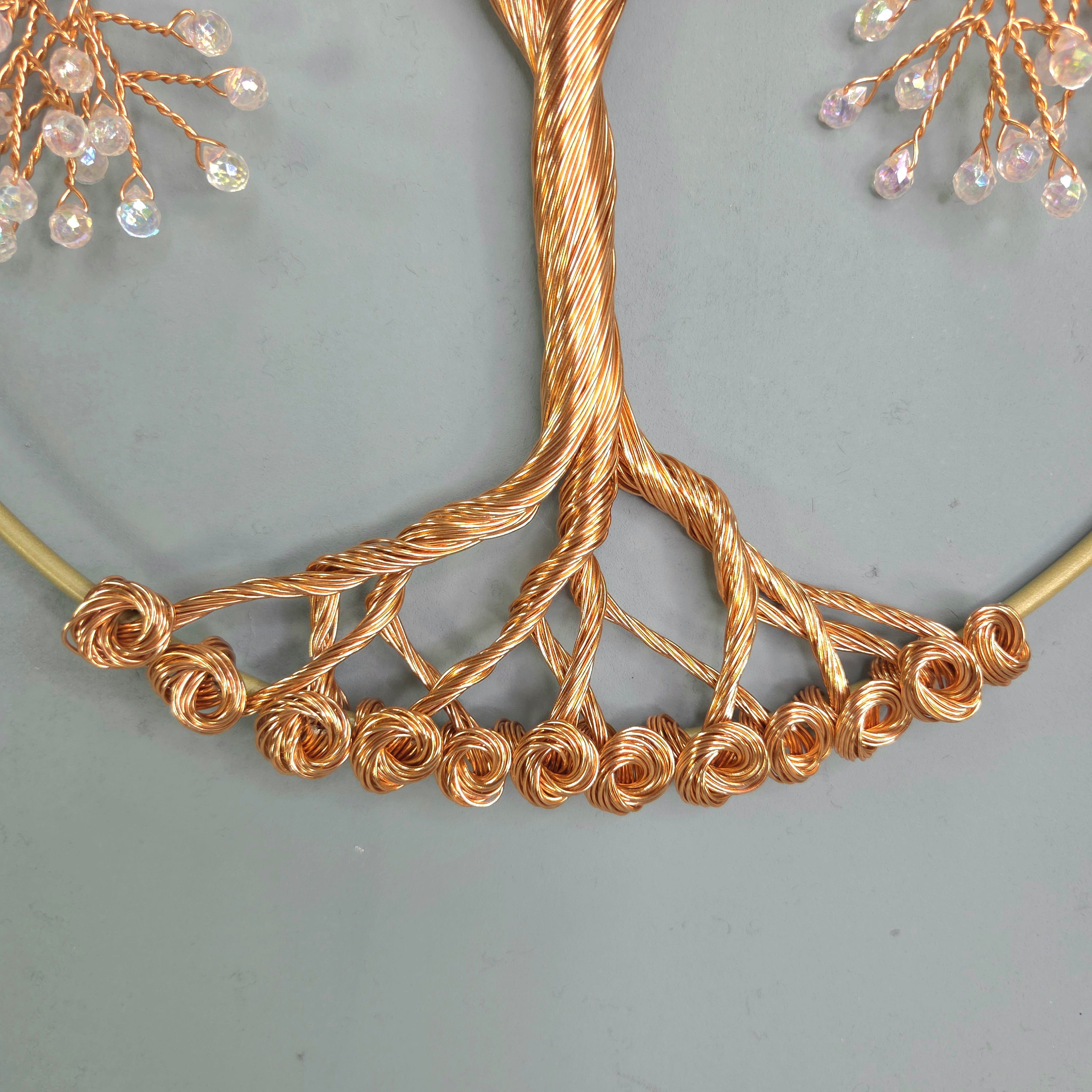 Gold necklace with intricate design on a light gray background