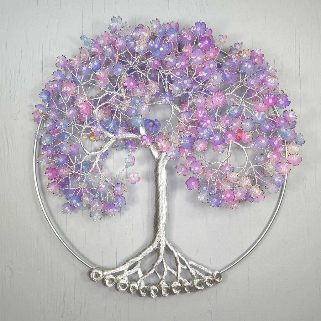 Decorative wall art of a tree with colorful beads on a light gray background