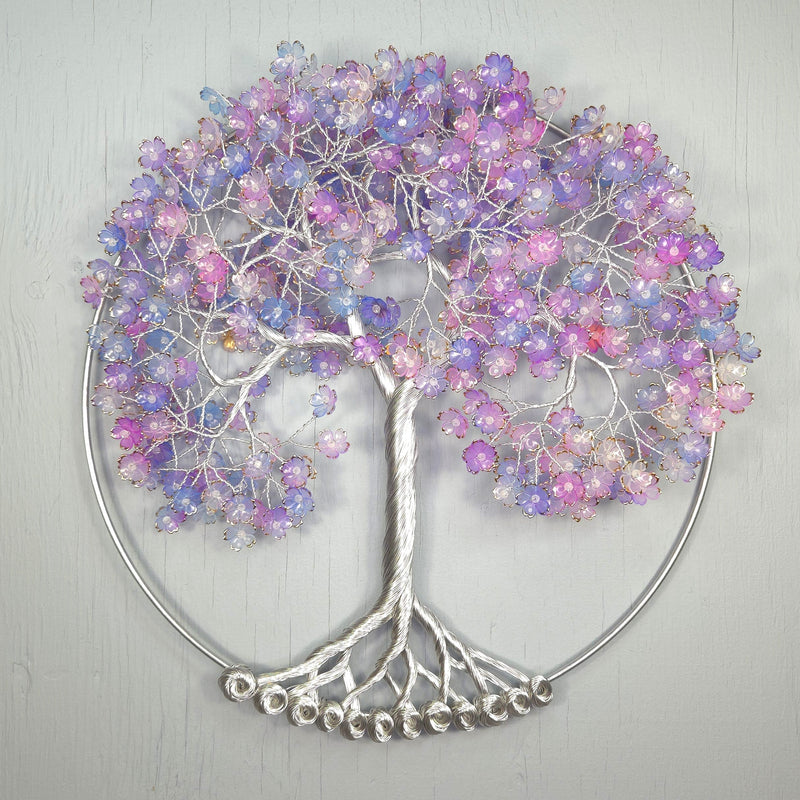 Decorative wall art of a tree with colorful beads on a light gray background