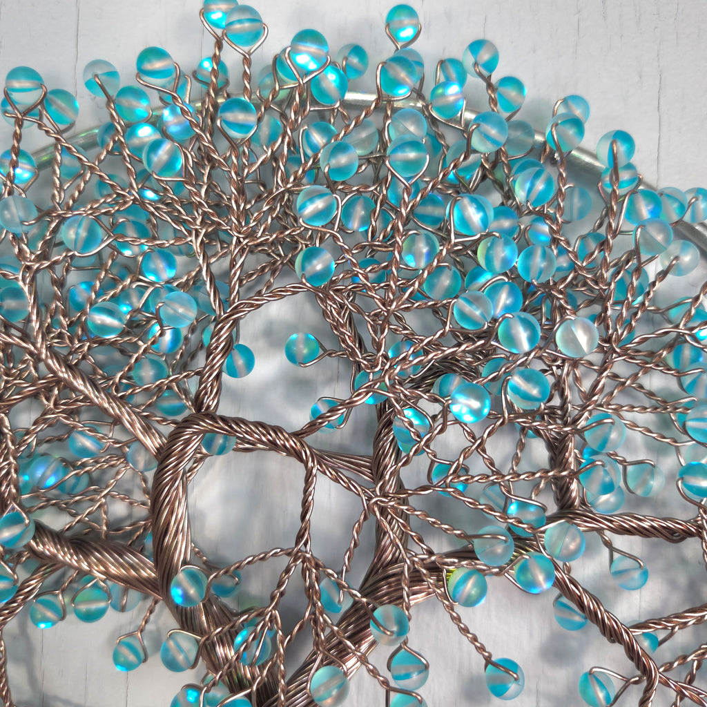 Decorative branch with blue beads on a white background