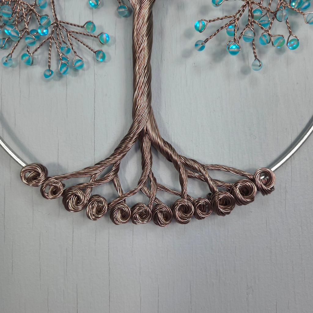 Decorative wreath with wire and bead design on a light gray background