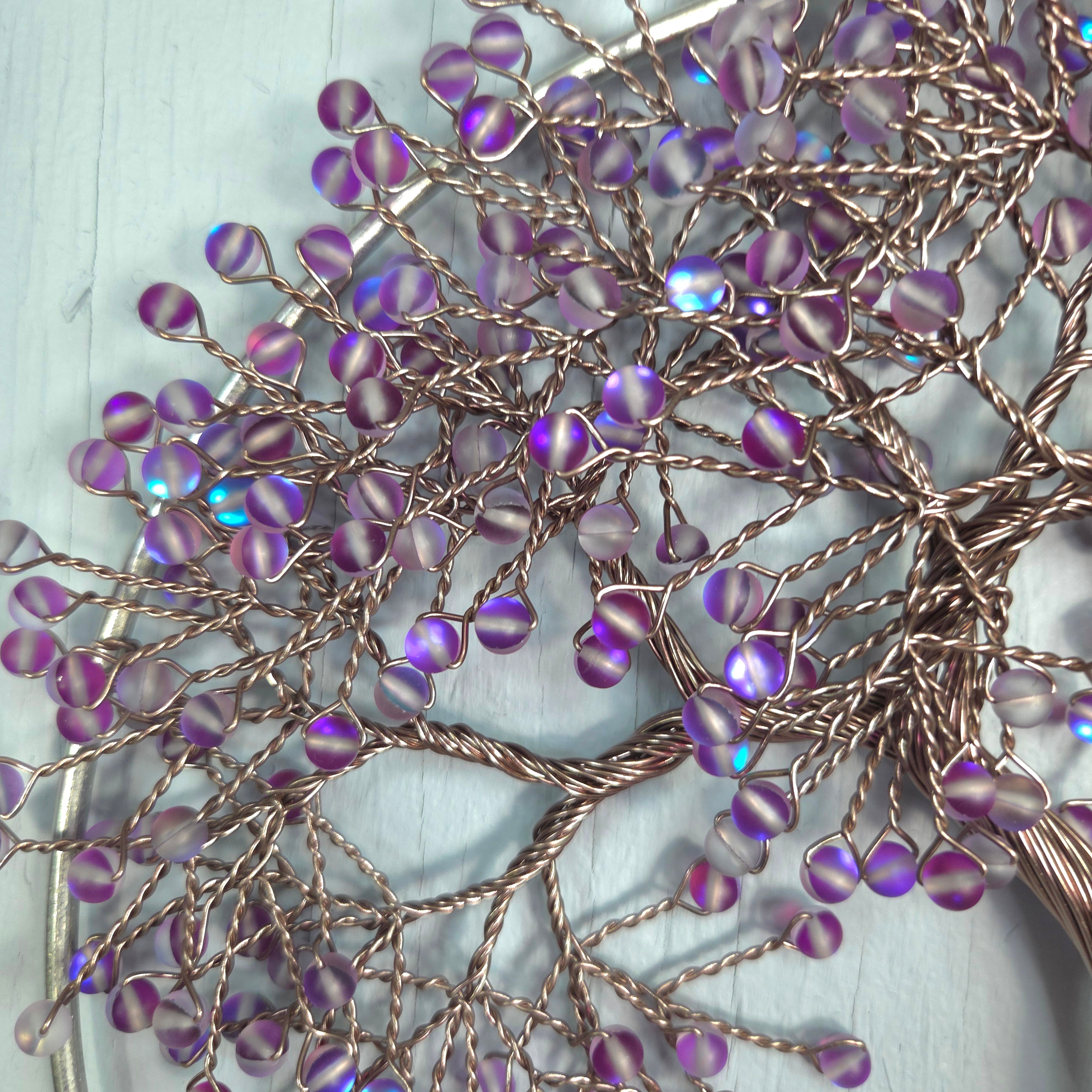 Purple beaded hairpins on a white background