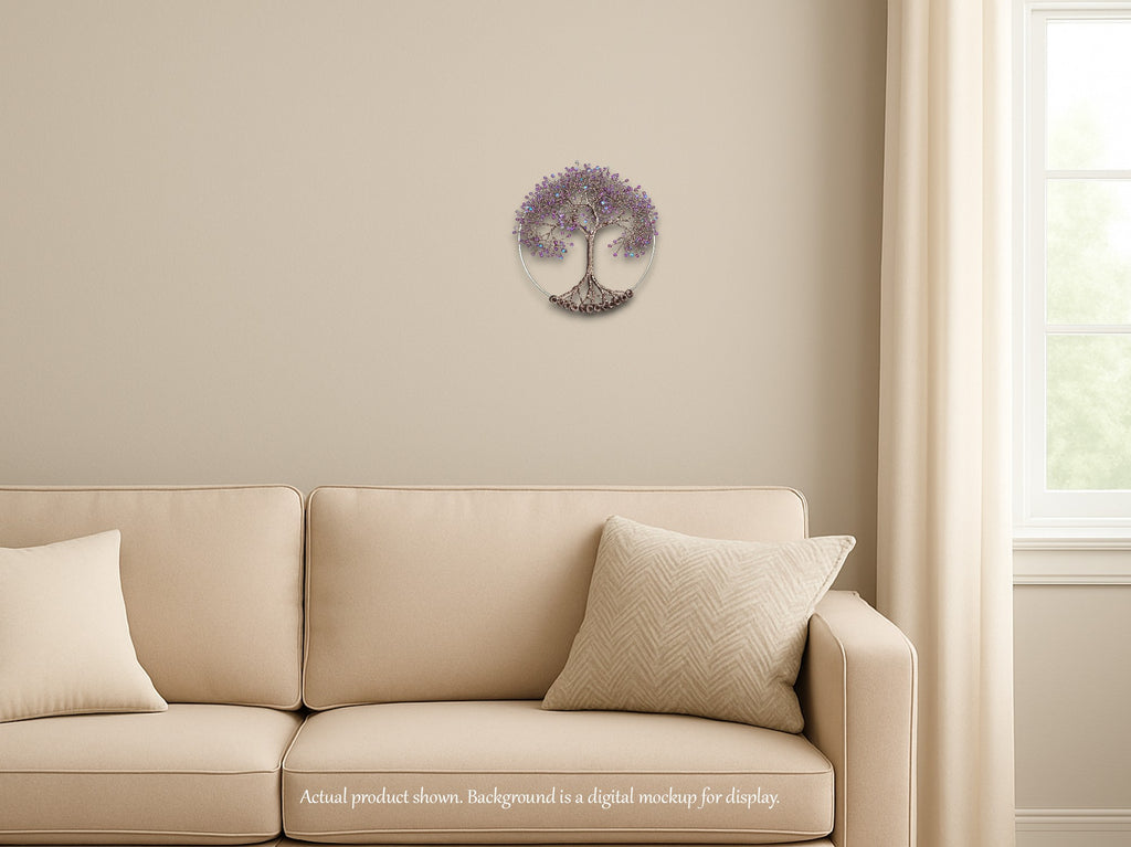 Beige sofa with decorative pillows in a room with a wall decal of a tree with purple flowers.
