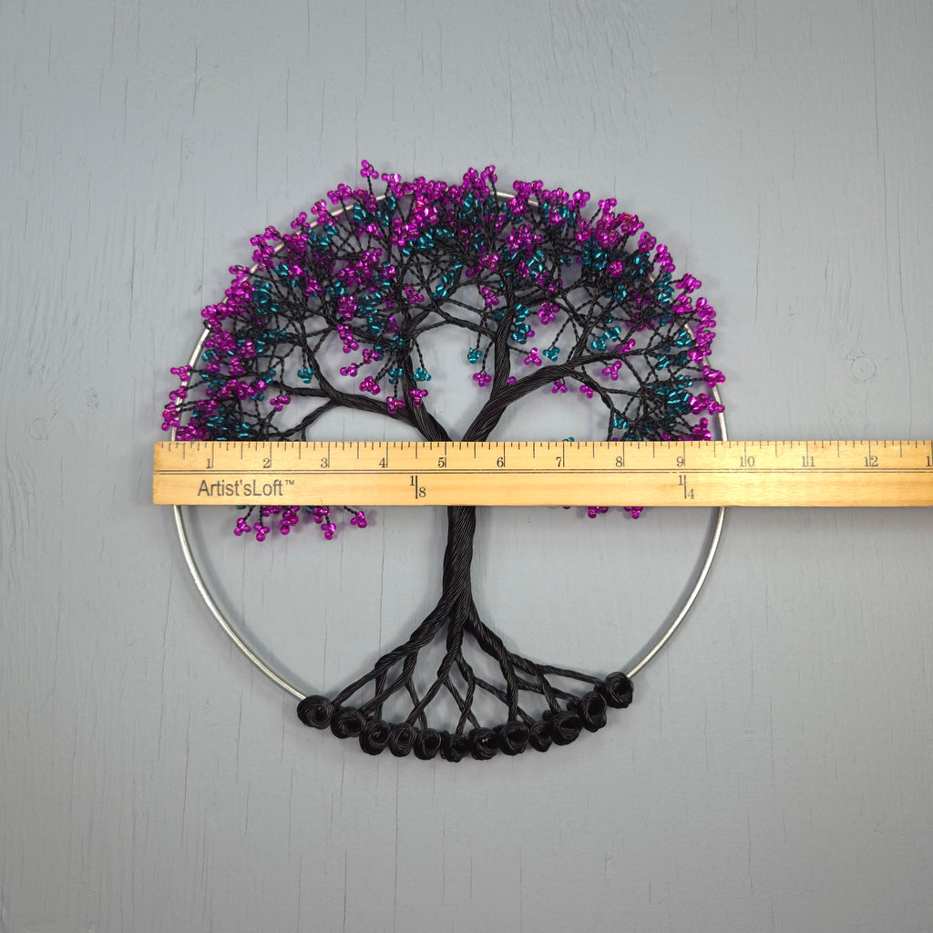 Decorative wall art with purple and black tree design on a gray background, measured by a ruler.