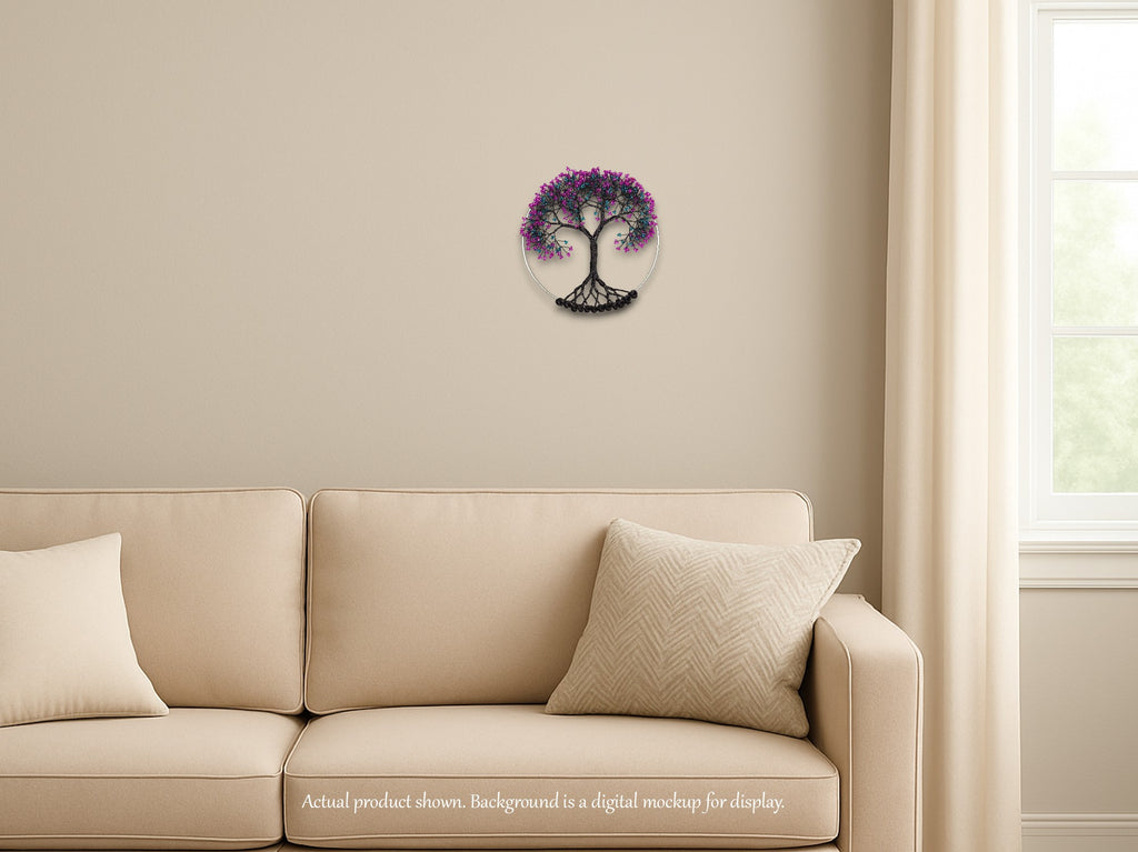 Decorative wall clock with tree design on a beige wall above a beige sofa.