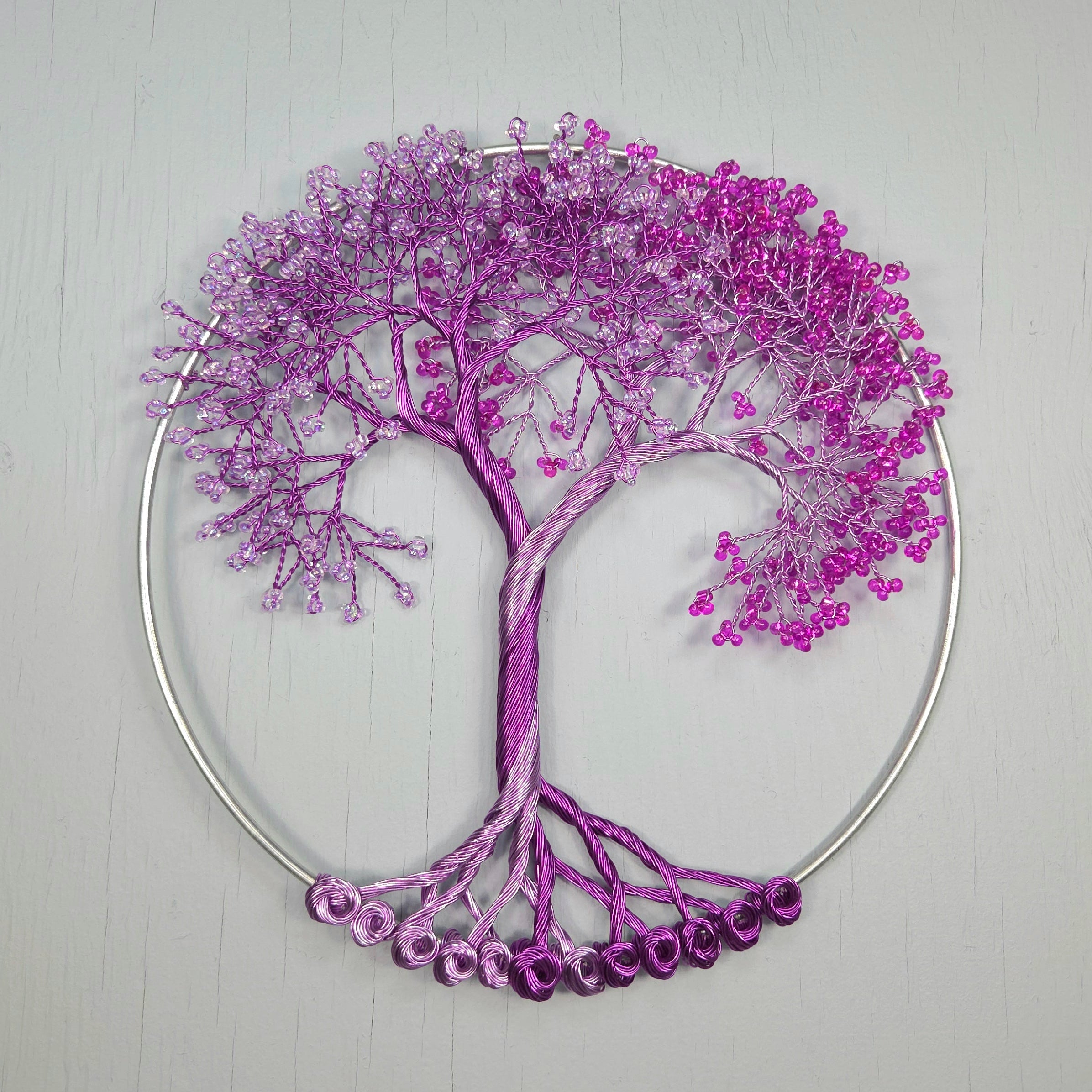 Decorative purple tree wall art on a light gray background