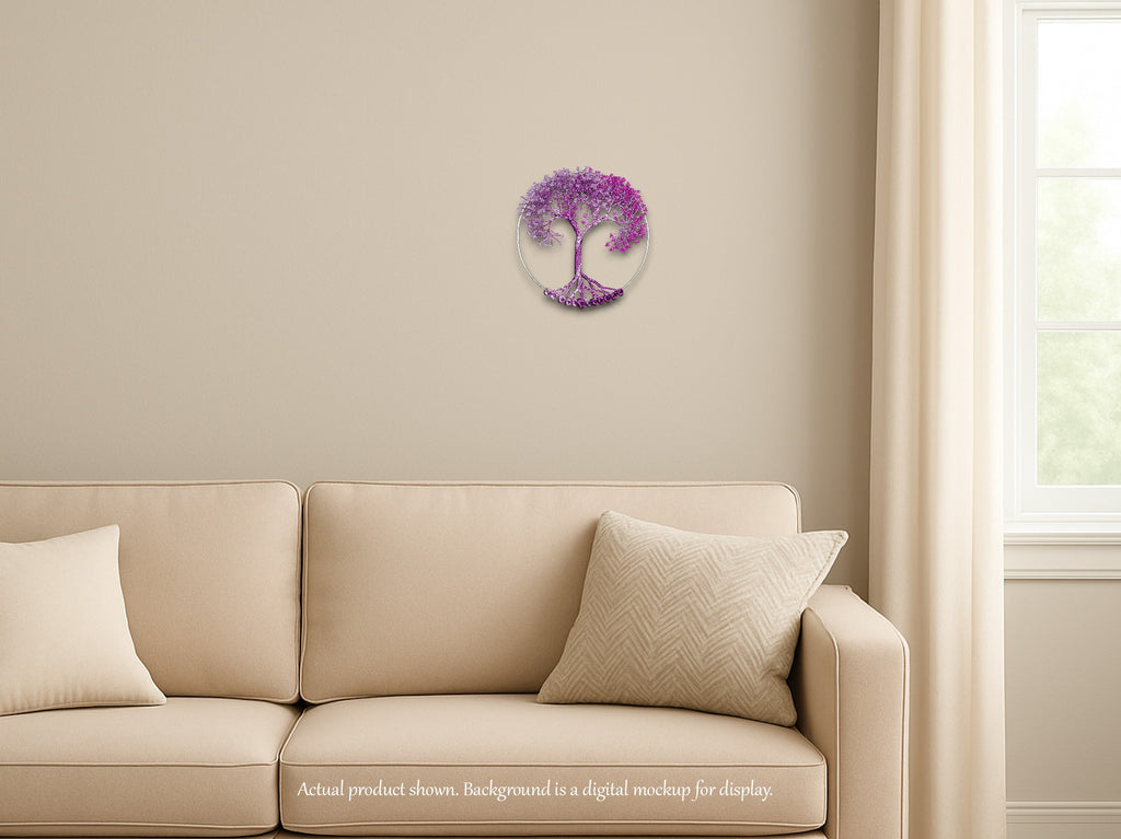 Beige sofa with decorative pillows against a beige wall with a purple tree of life wall art.