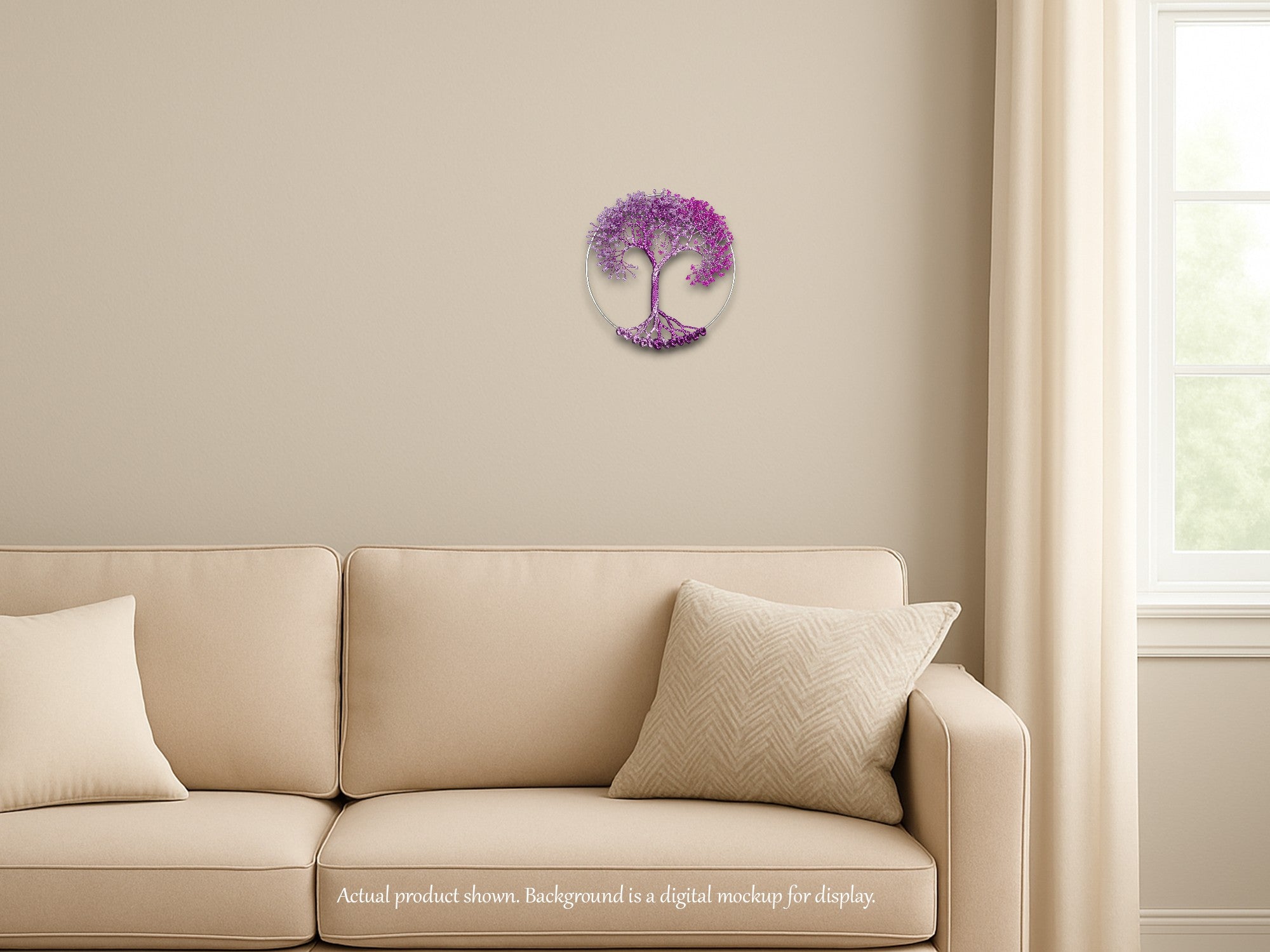 Beige sofa with decorative pillows against a beige wall with a purple tree of life wall art.