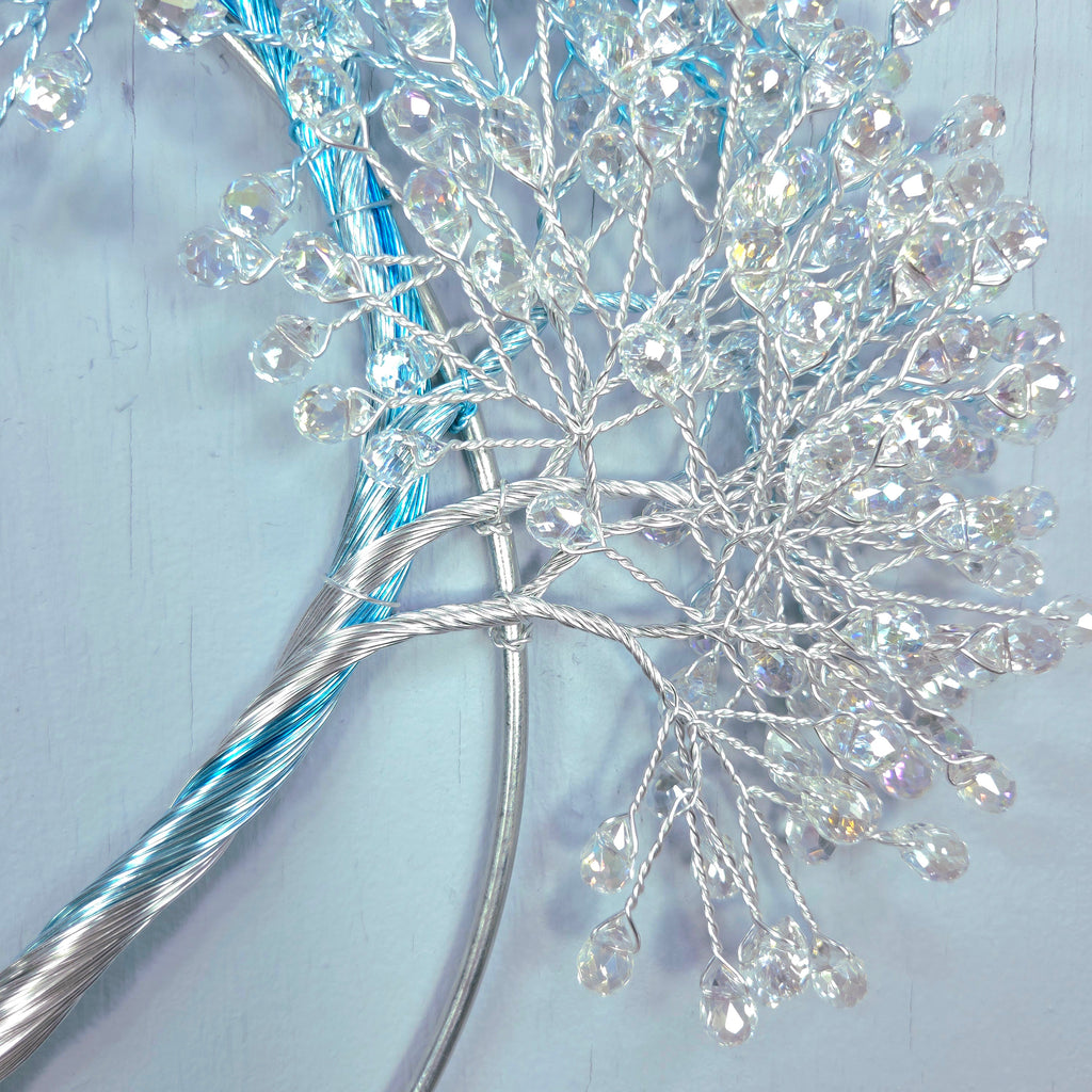 Decorative branch with crystals on a light blue background