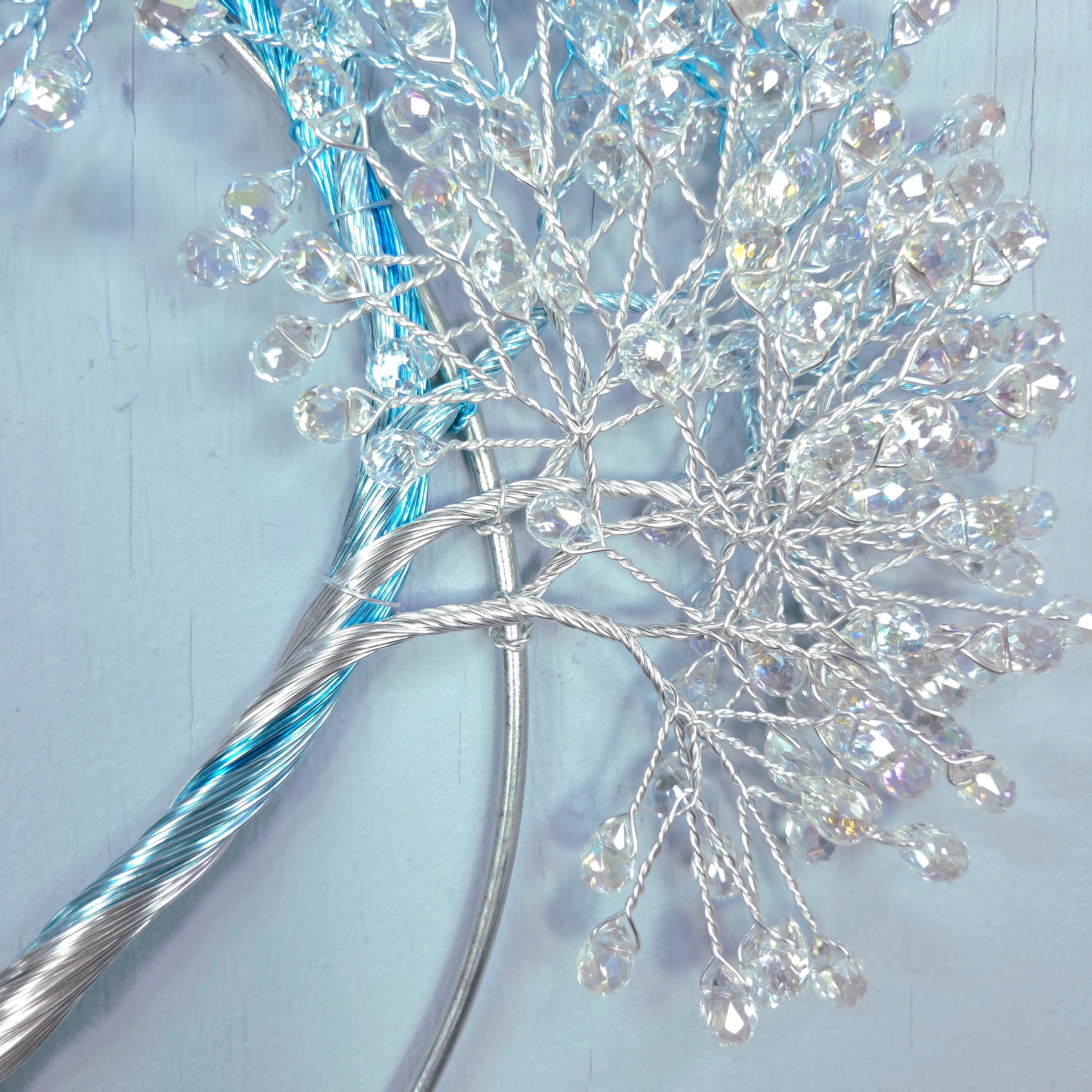 Decorative branch with crystals on a light blue background