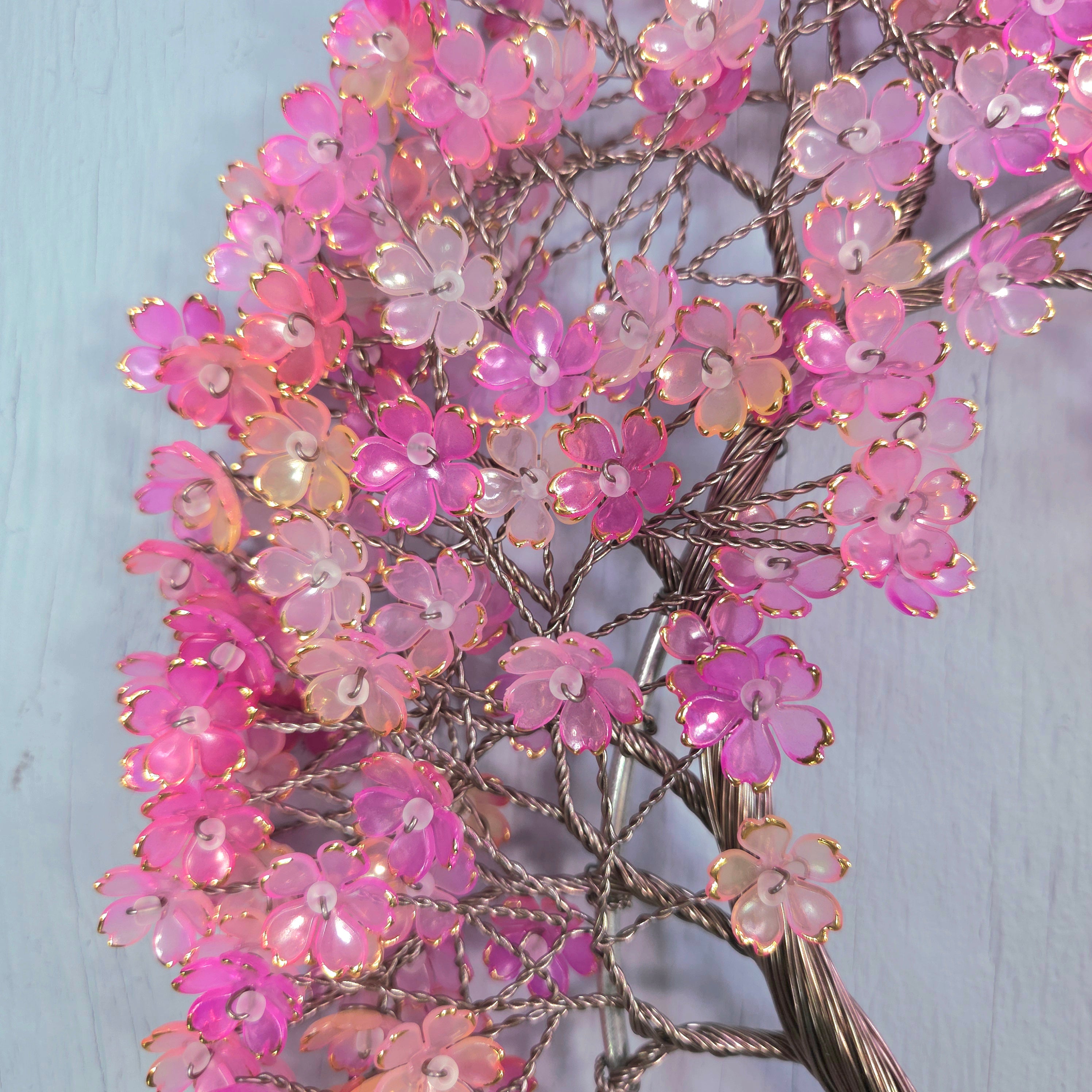 Decorative branch with pink flowers on a light blue background