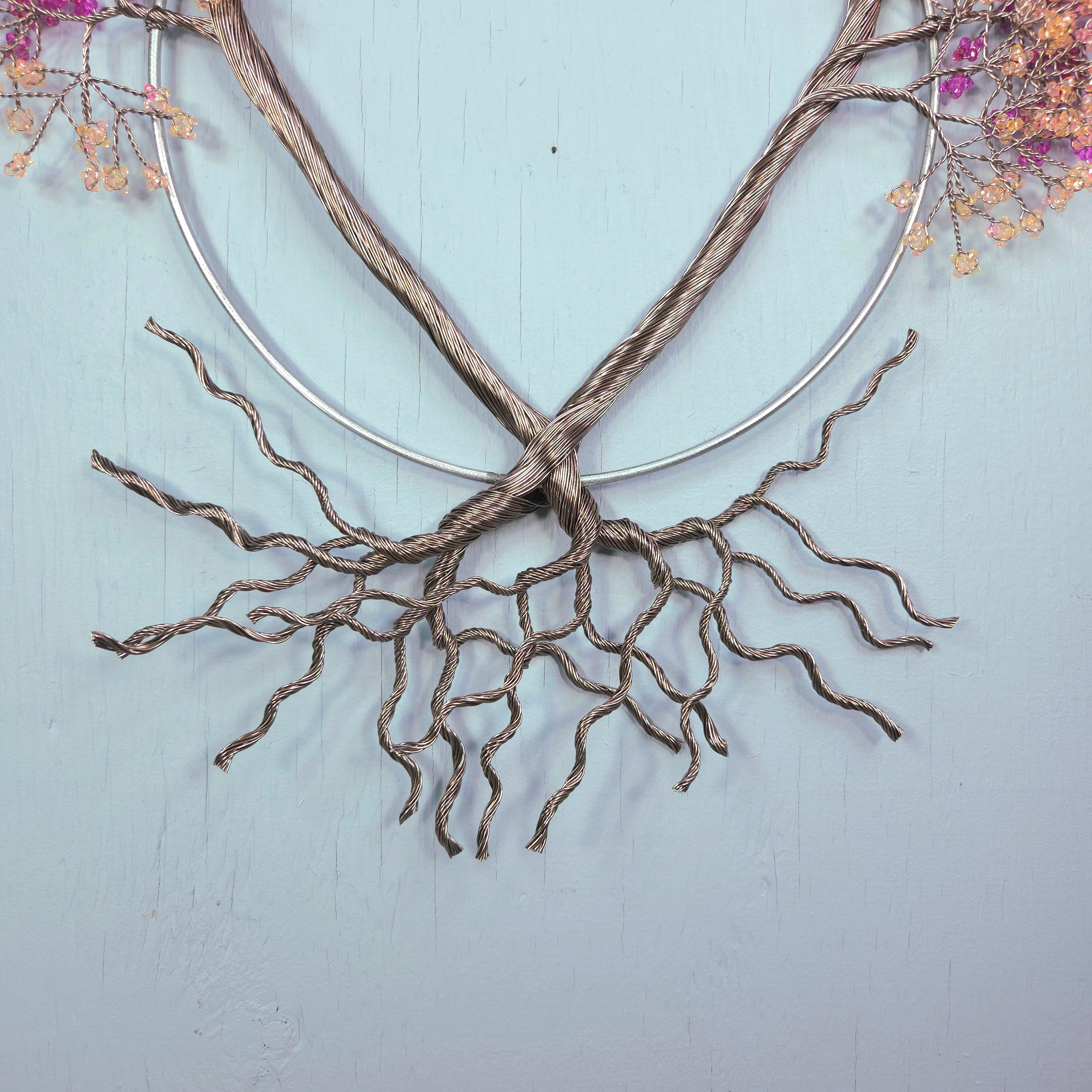 Decorative branch with roots on a light blue background