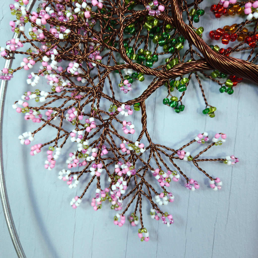 Decorative wreath with beaded branches on a light blue background