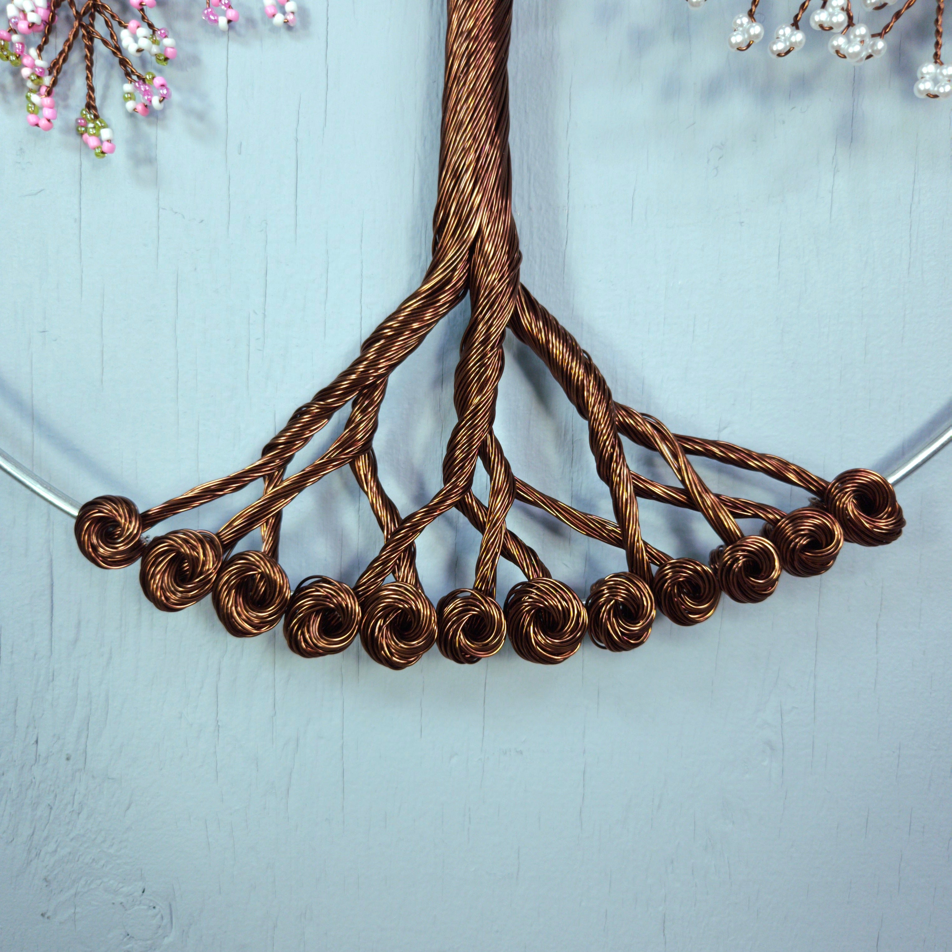 Close-up of a braided brown cord on a light blue background