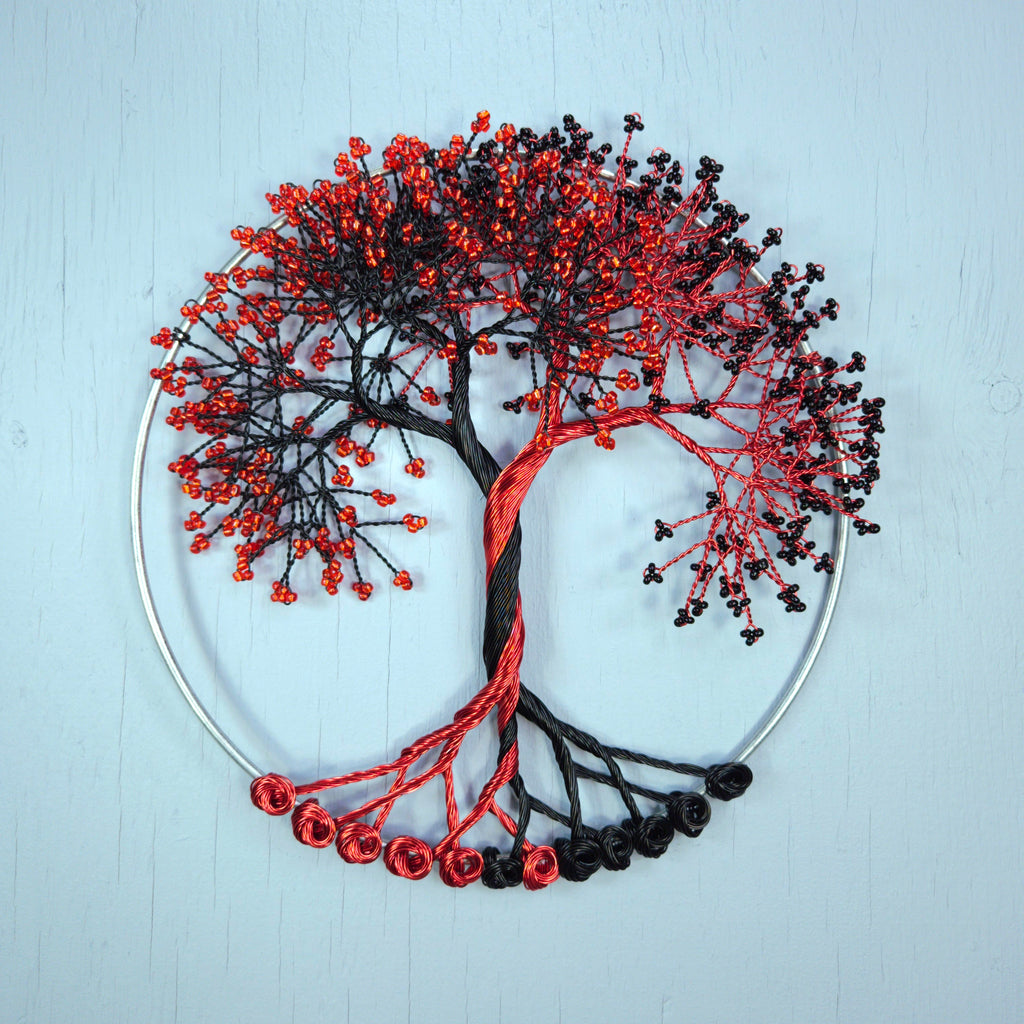 Decorative tree of life with red and black branches on a light blue background