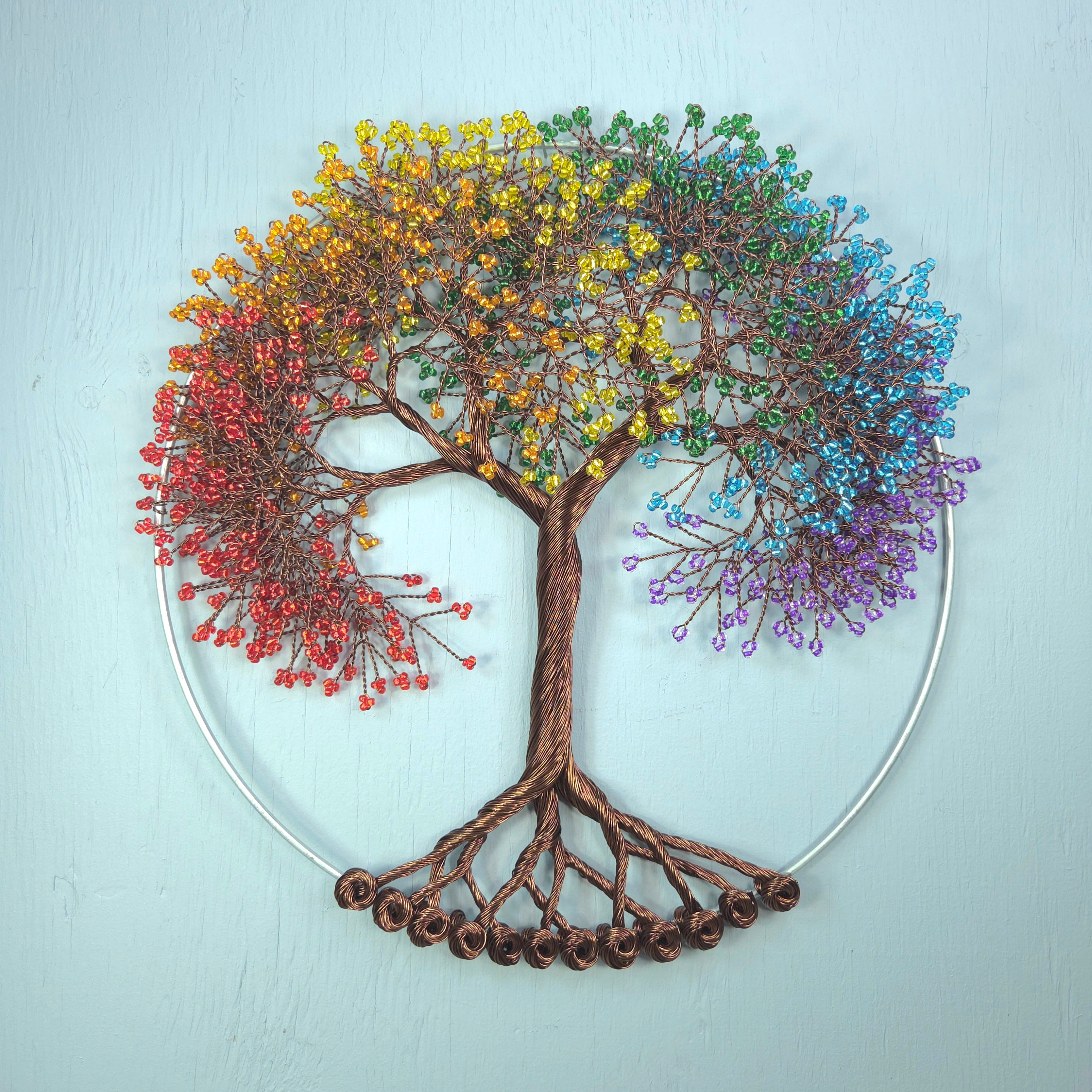 Colorful tree of life wall art on a light blue background