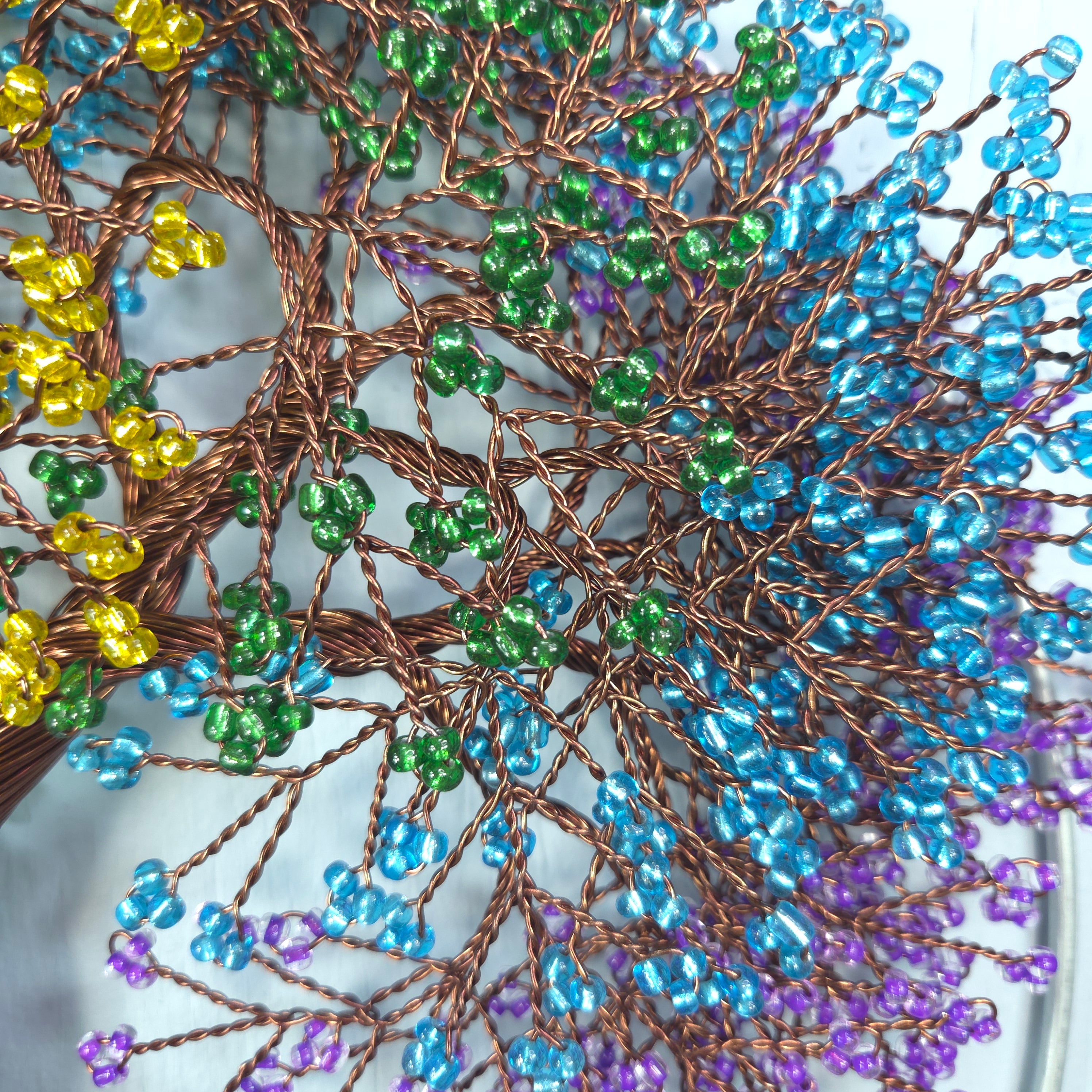 Decorative wreath with multicolored beads on a white background